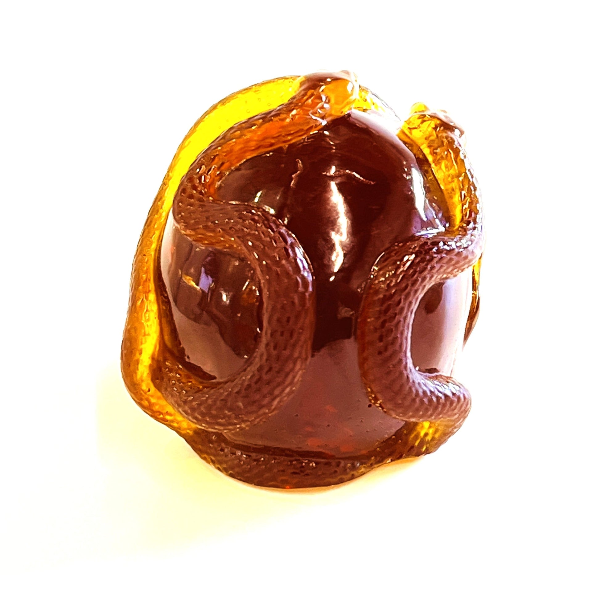 Handmade Baltic amber skull and snake by KIZIMA® USA — natural amber decor, side view