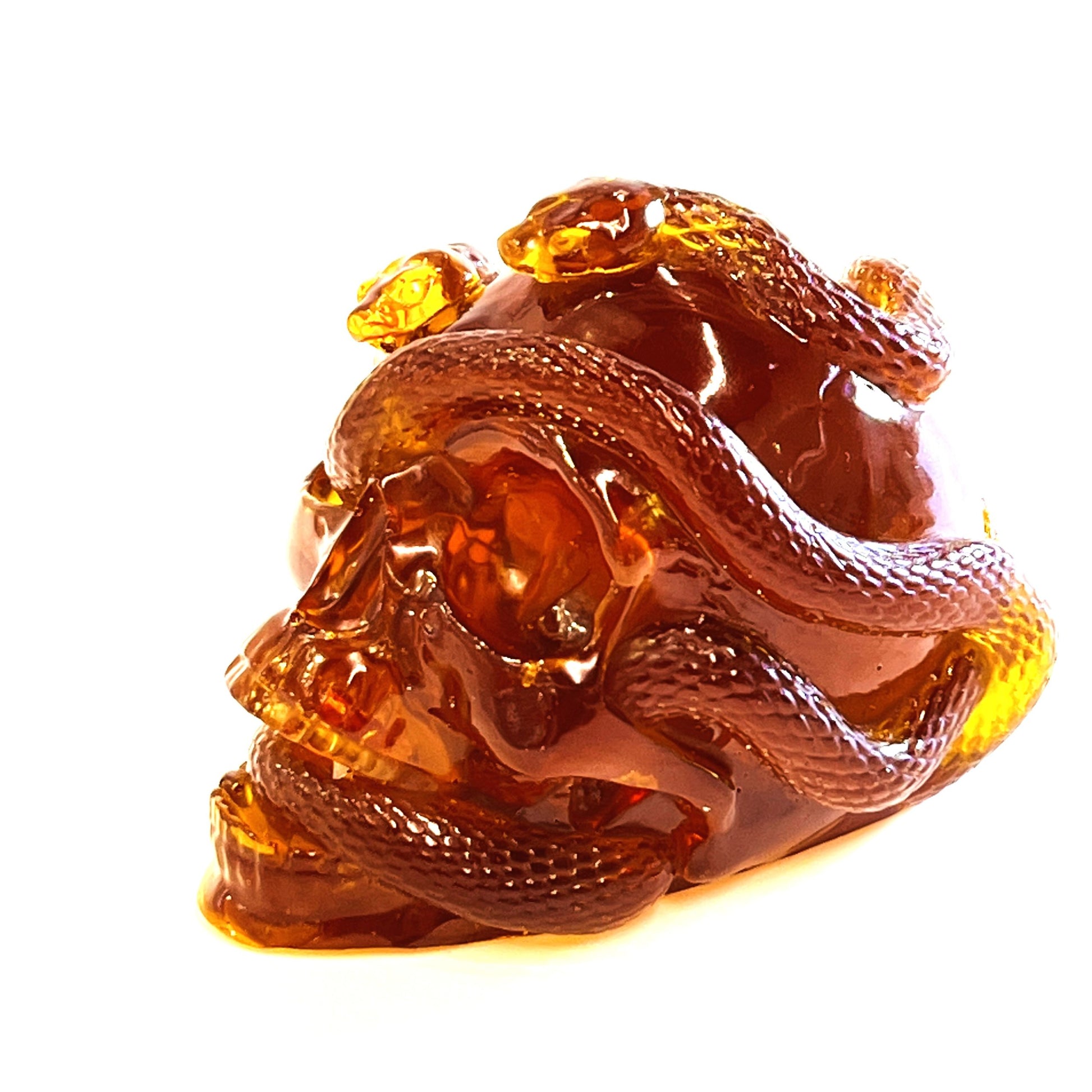 KIZIMA® amber skull and snake figurine — genuine Baltic amber decor, handmade in USA, angled view