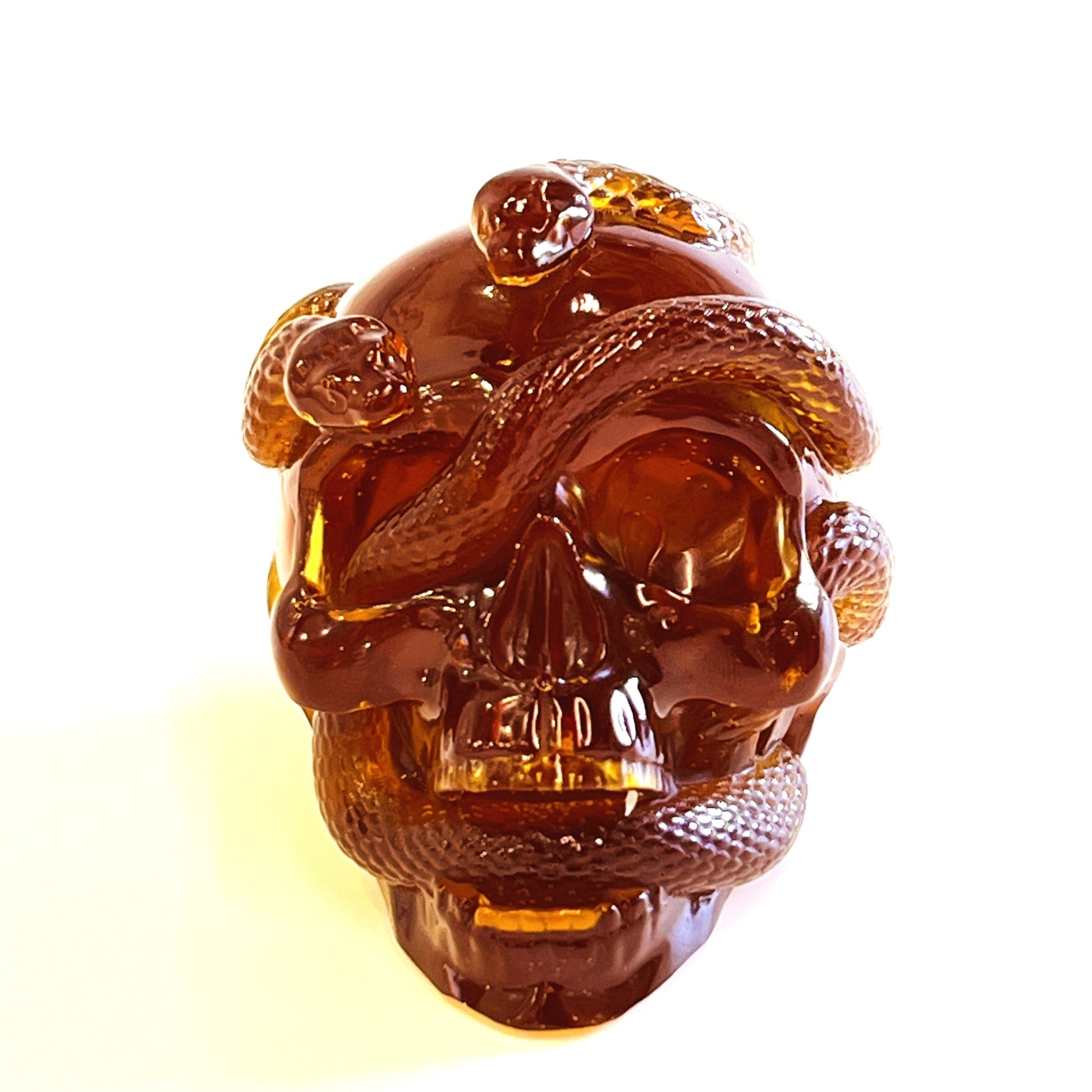 Baltic amber skull and snake figurine by KIZIMA® — genuine amber, handmade in USA, side angle