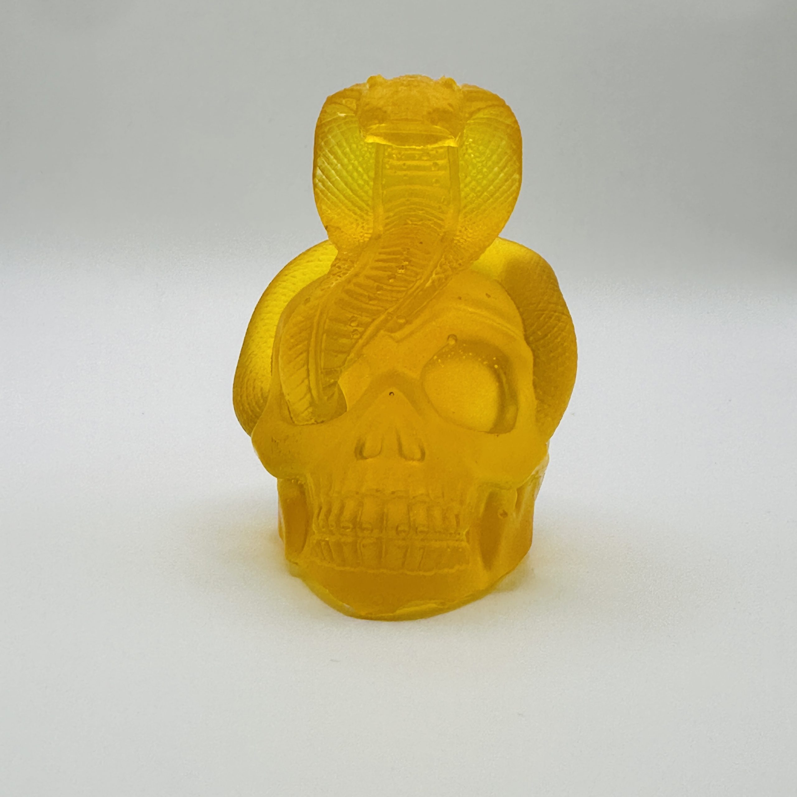 Handmade Baltic amber snake and skull by KIZIMA® USA — natural amber decor, side view