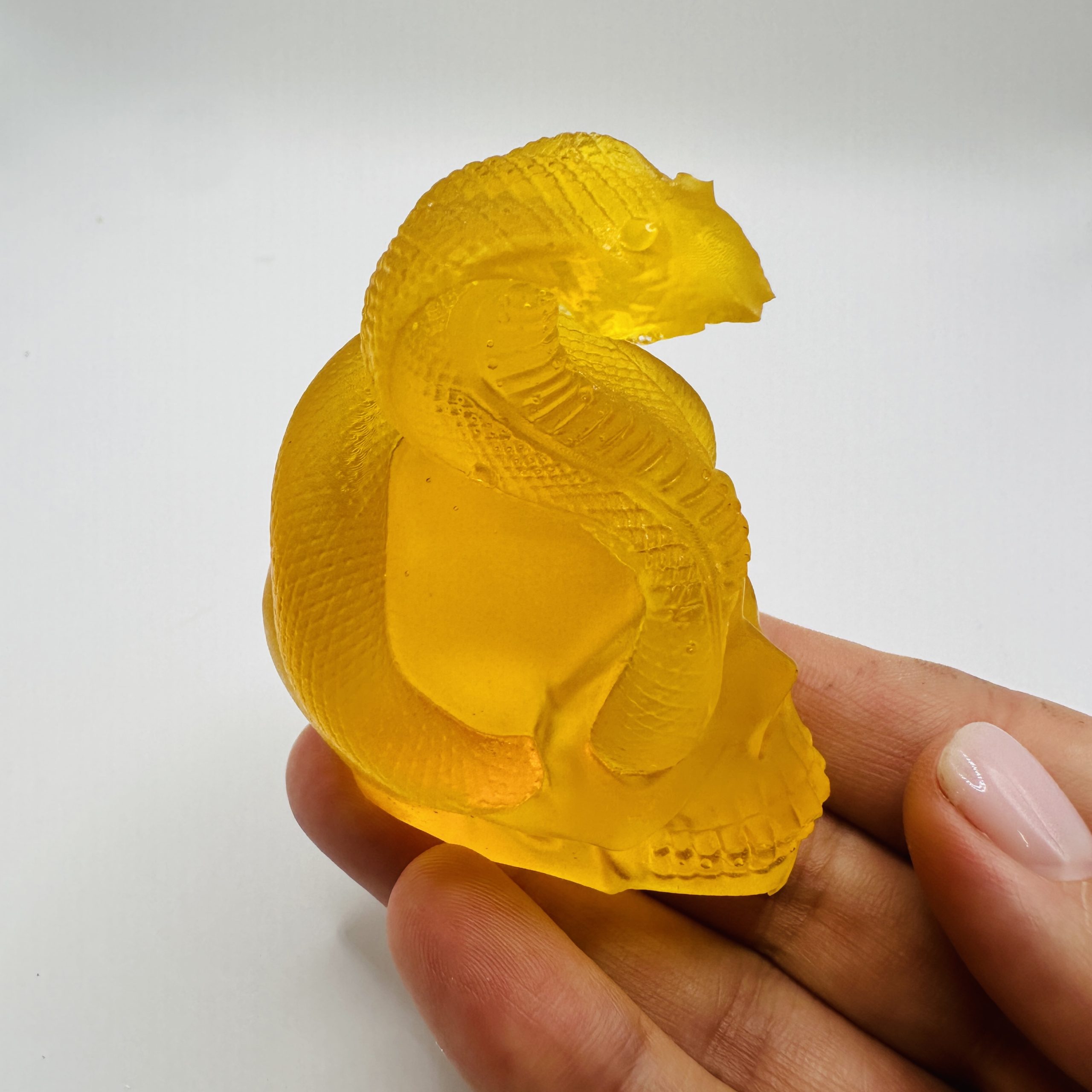 KIZIMA® amber snake skull figurine — genuine Baltic amber decor, handmade in USA, angled view