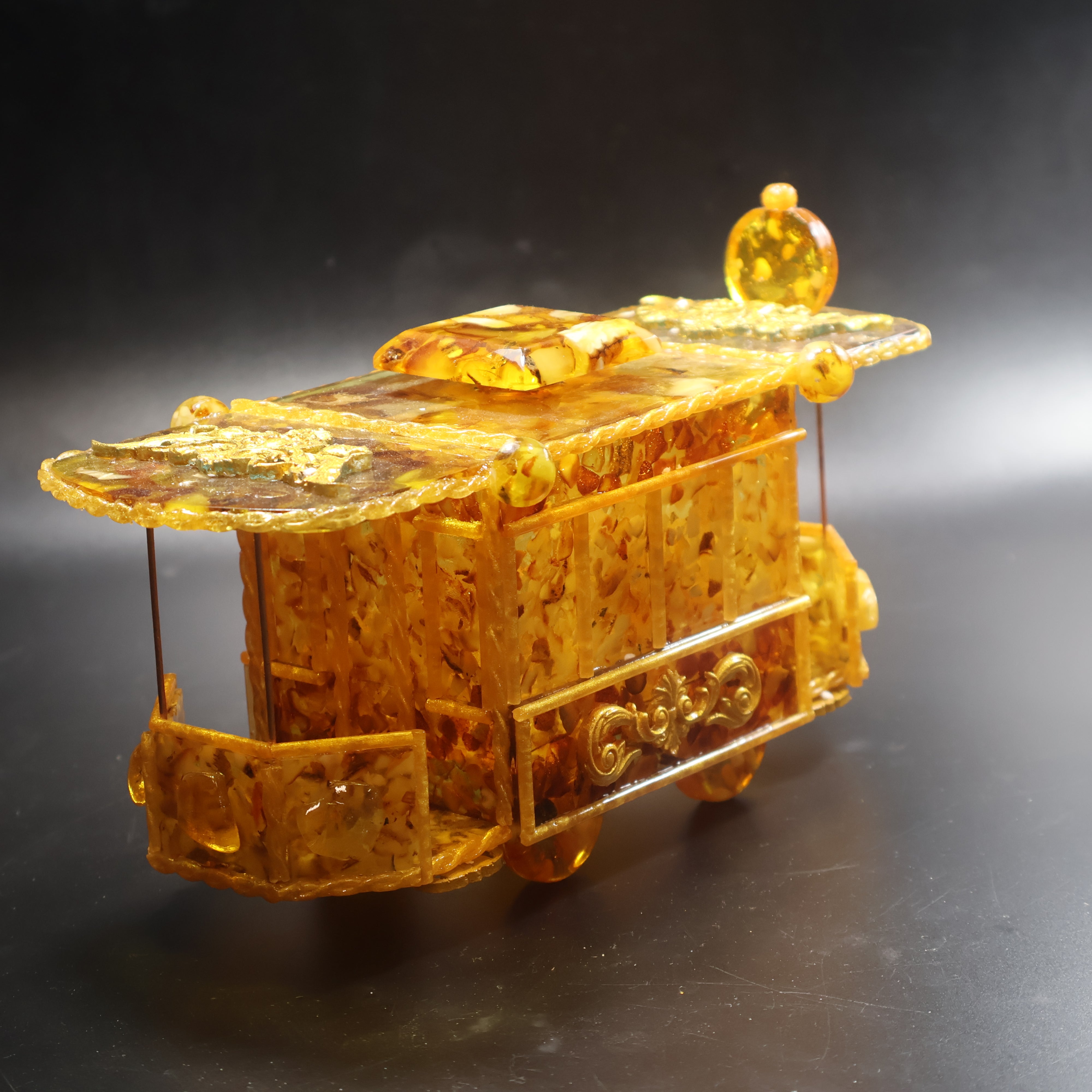 Natural Baltic Amber tram jewelry box rear view showing polished amber back panel and dark wheels