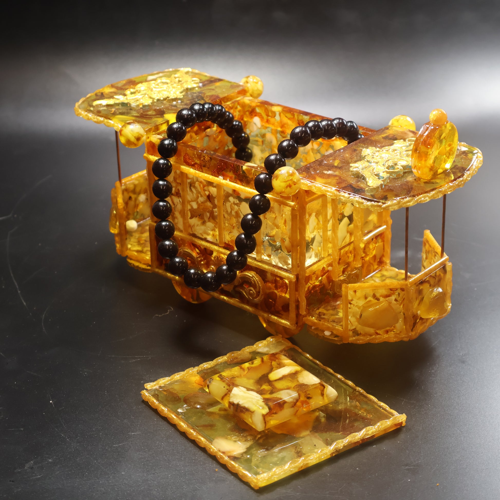 Top view of Natural Baltic Amber tram jewelry box showing polished amber roof lid, handcrafted in USA