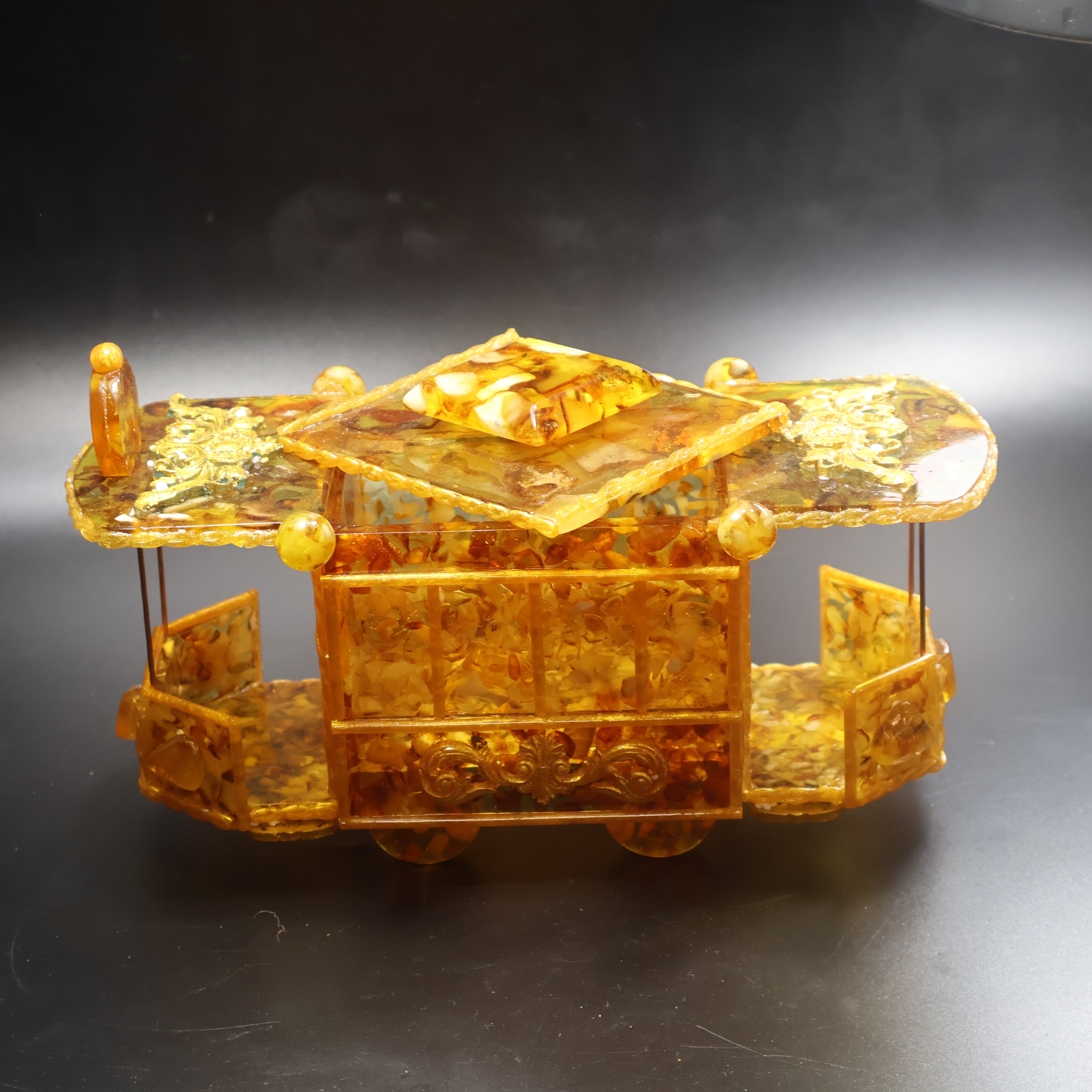 Natural Baltic Amber tram trolley jewelry box side profile view showing honey and cognac amber panels and arched windows