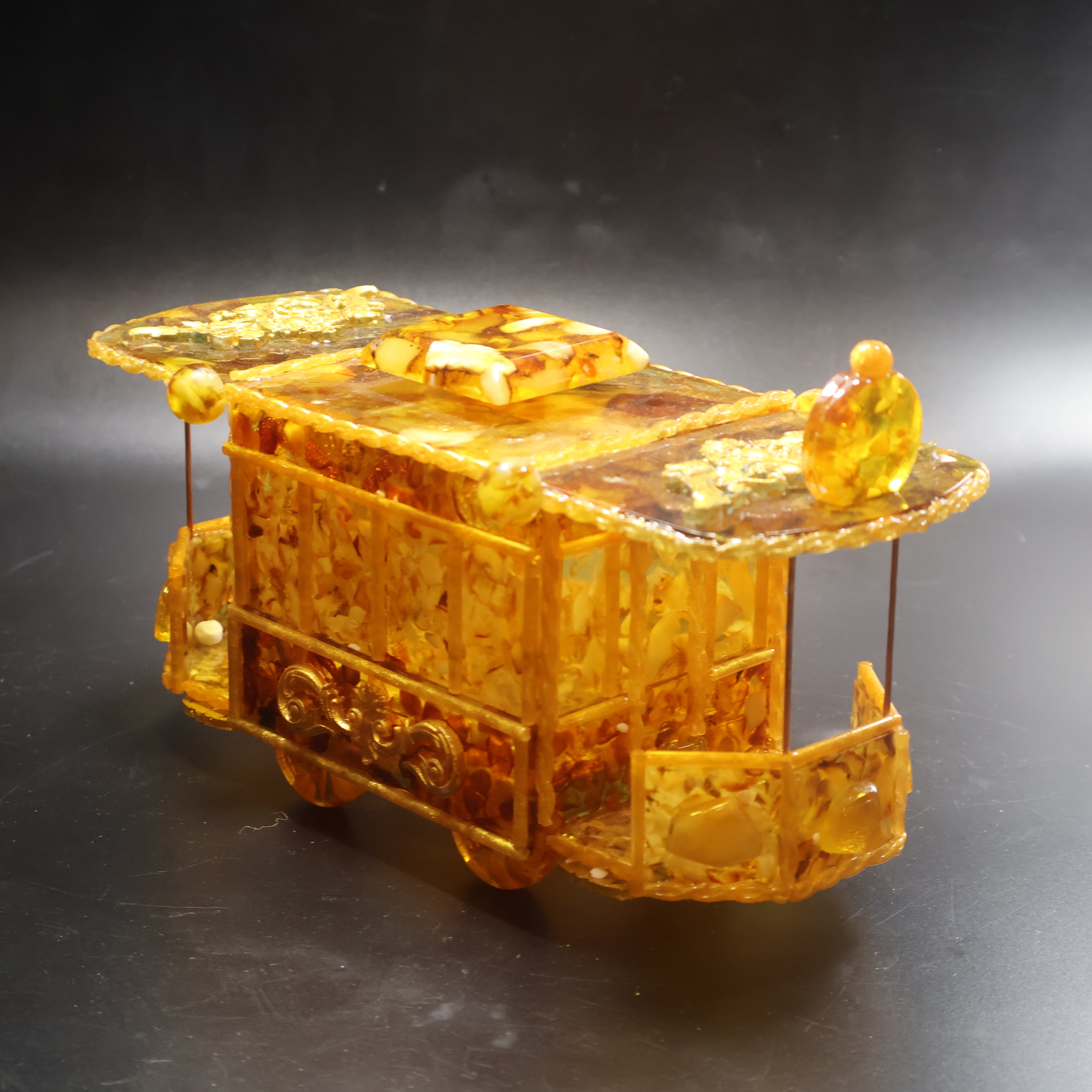 Vintage tram shaped Baltic Amber trinket box front view with driver cab windows and amber details