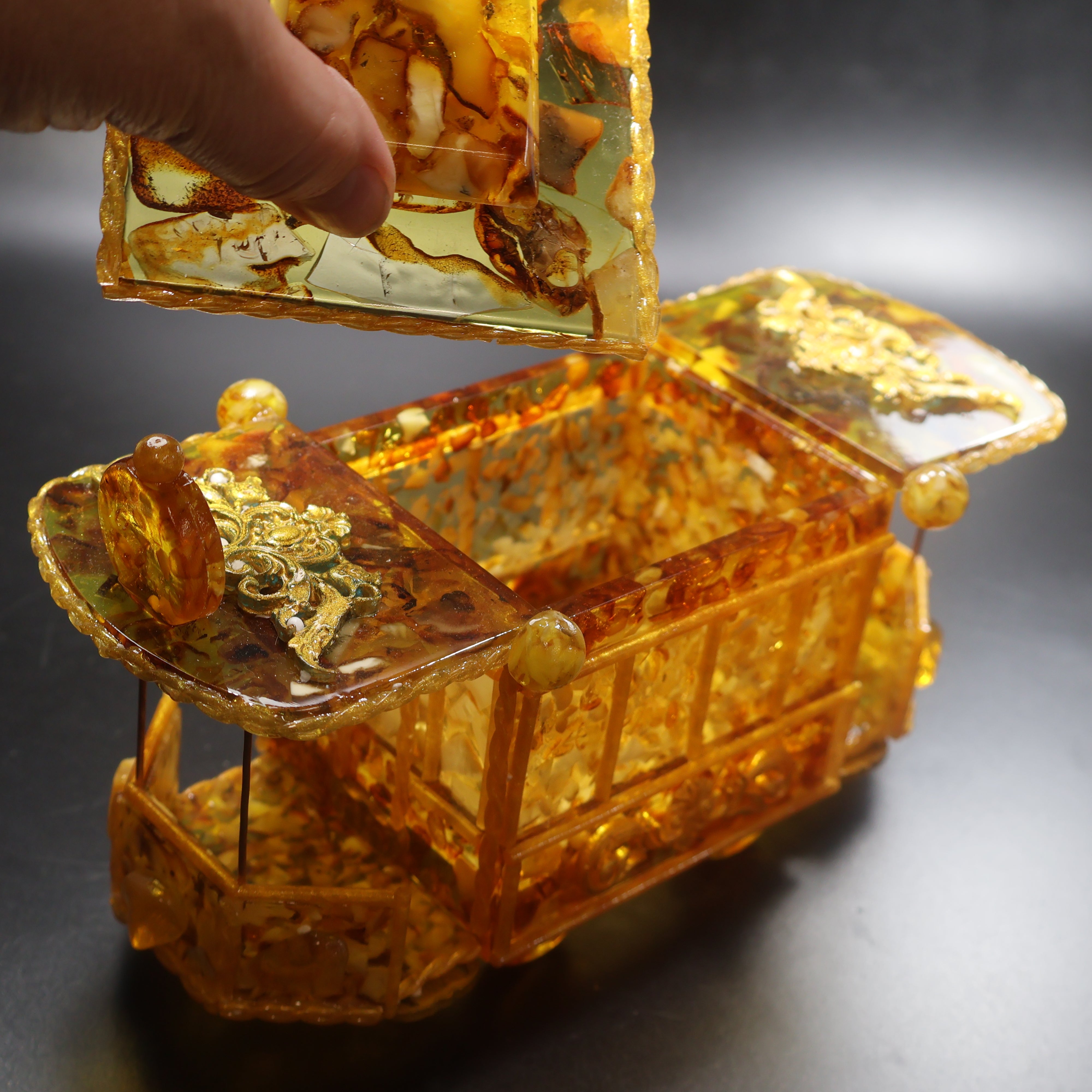 Natural Baltic Amber vintage trolley car jewelry box detail view showing hand-polished amber craftsmanship