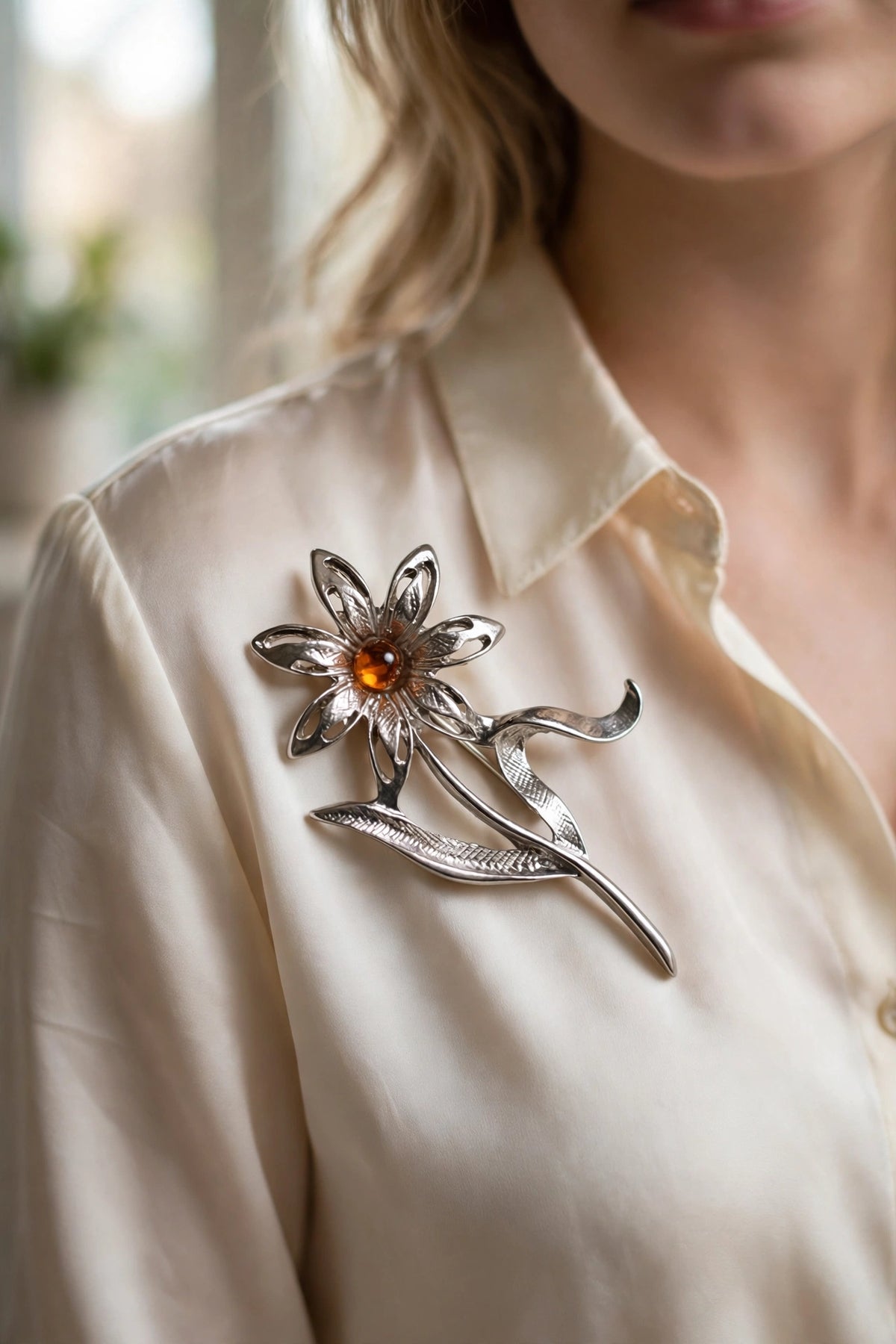 Handmade Baltic amber daisy brooch worn on a model — KIZIMA, Made in USA