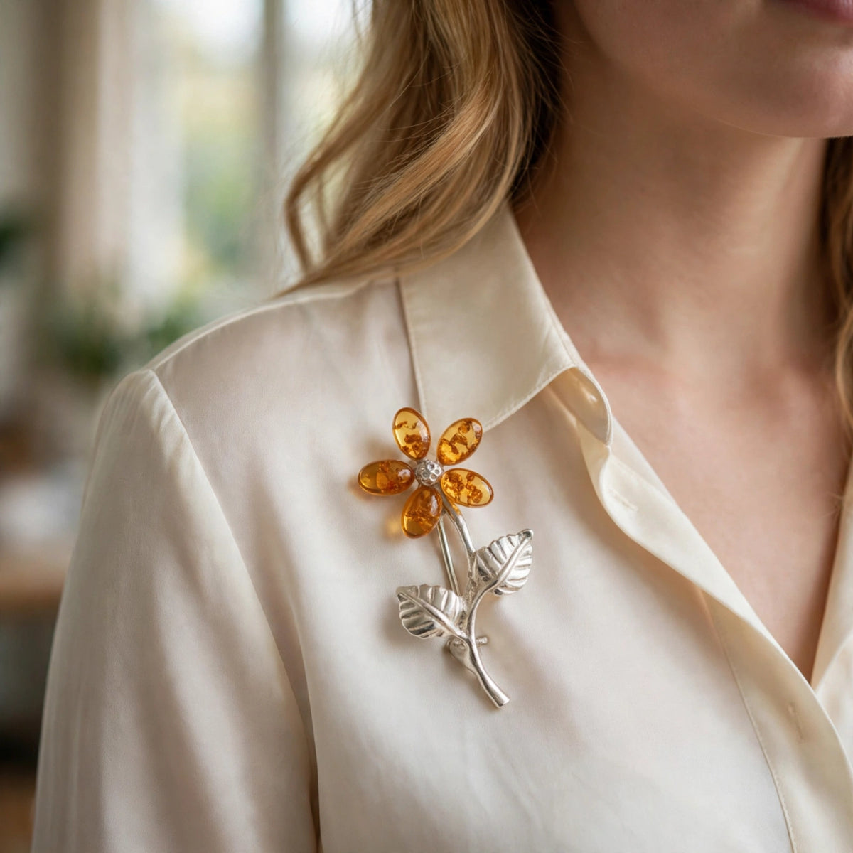 Handmade Baltic amber flower brooch worn on a model — KIZIMA, Made in USA