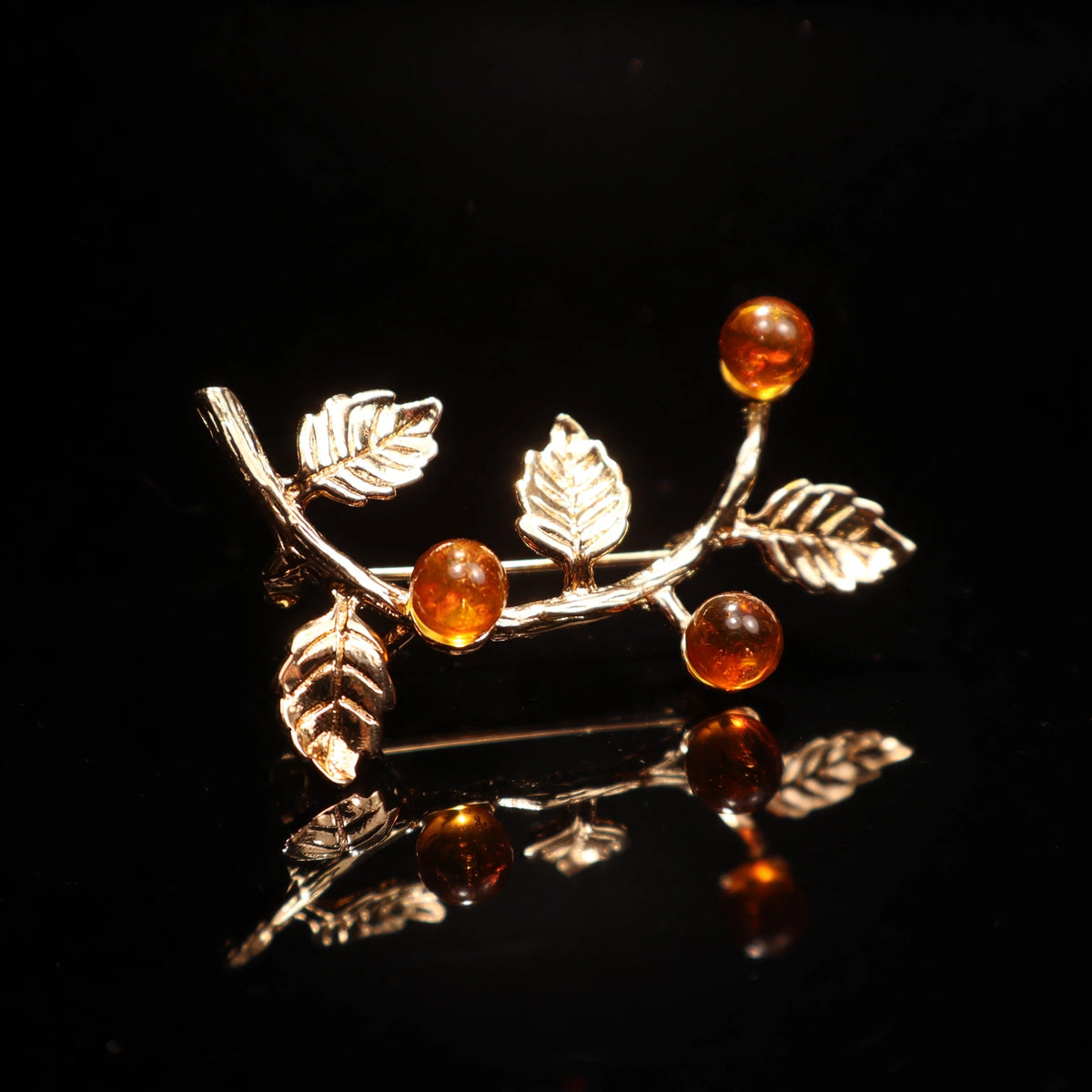 Handmade Baltic amber honey brooch, luxury studio photo on black background — KIZIMA, Made in USA