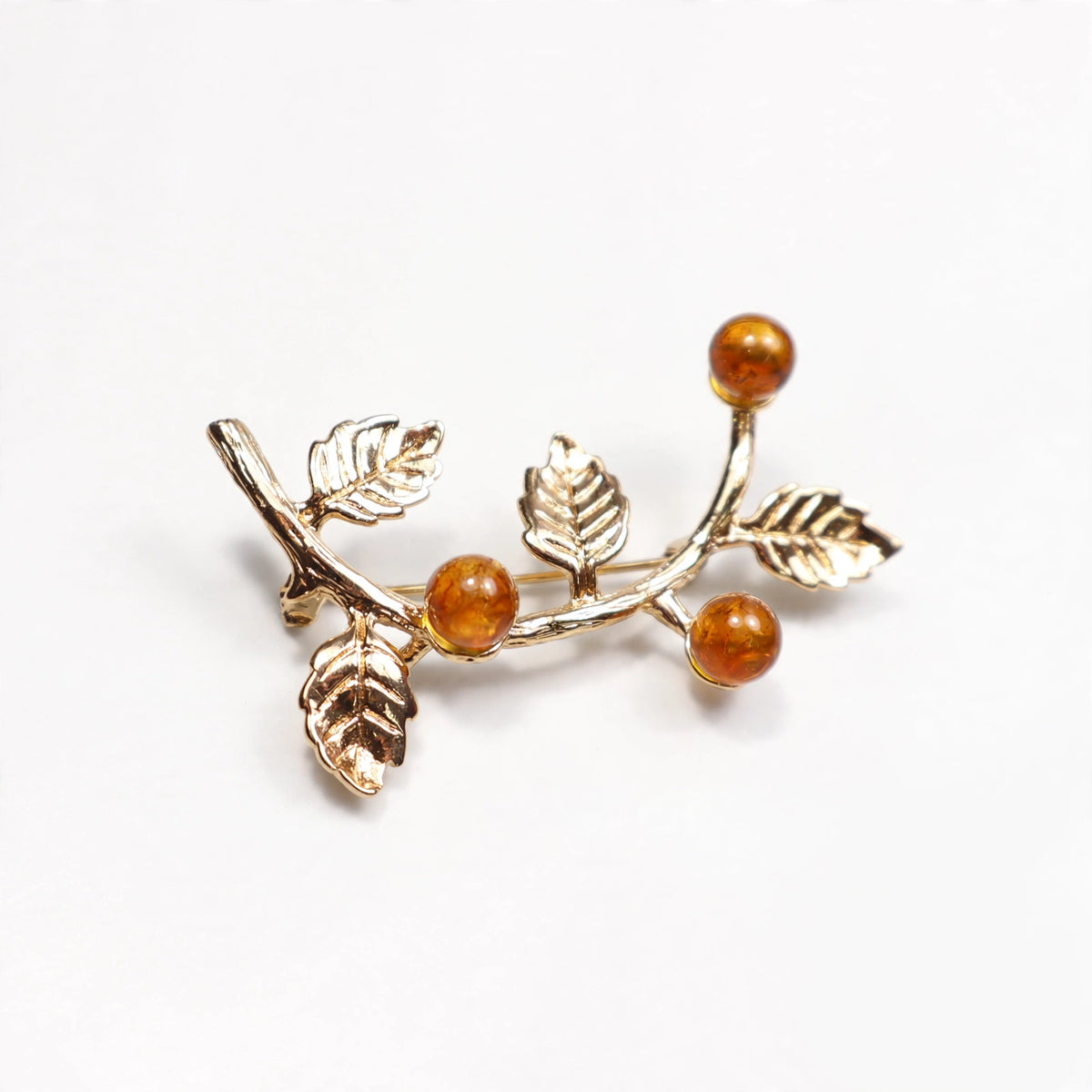 Handmade Baltic amber honey brooch on white background — KIZIMA, Made in USA