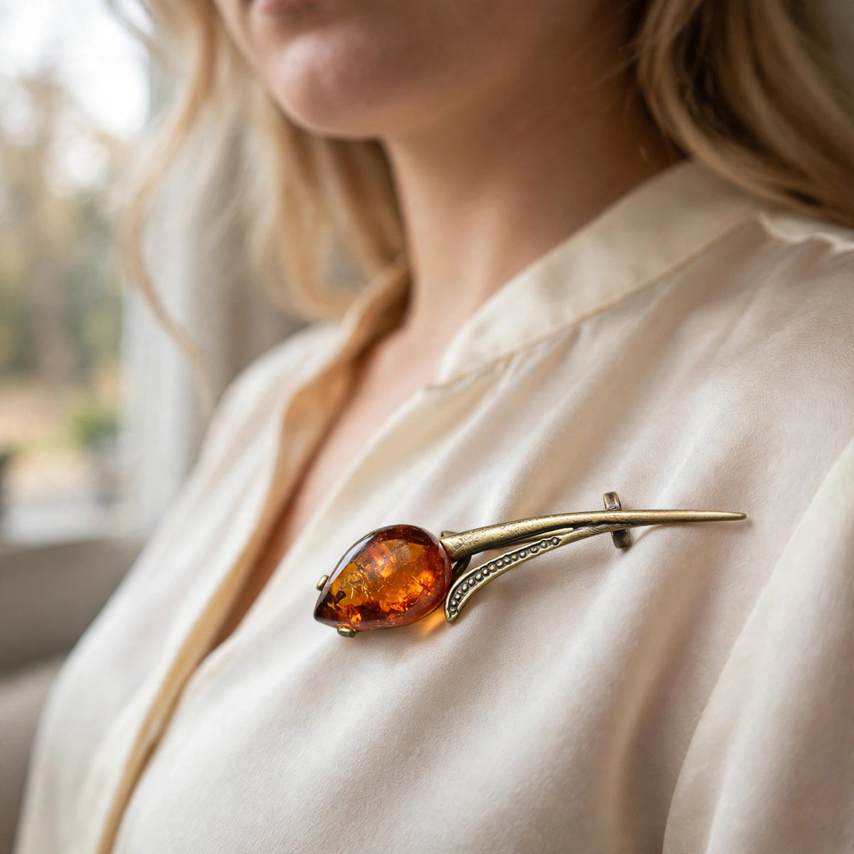 Handmade Baltic amber tulip brooch worn on a model — KIZIMA, Made in USA