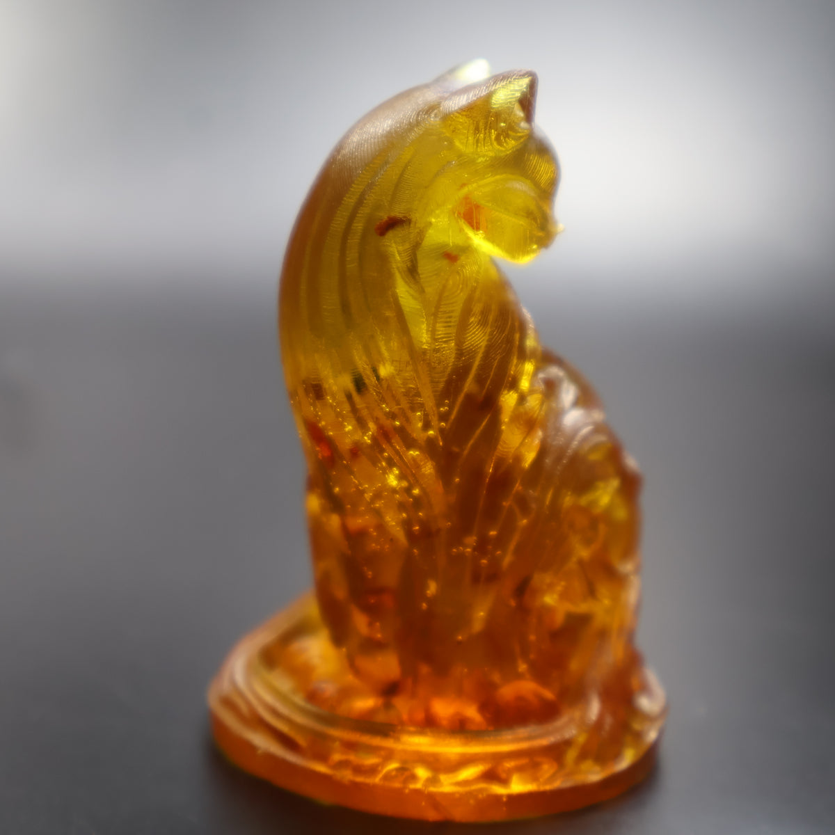 Baltic amber cat figurine on oval base front view, handmade amber art gift