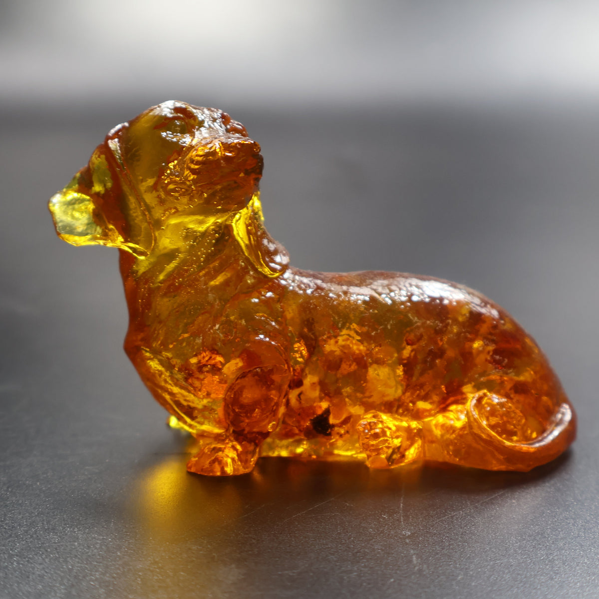 Natural Baltic amber Dachshund dog figurine lying down handcrafted in USA by KIZIMA