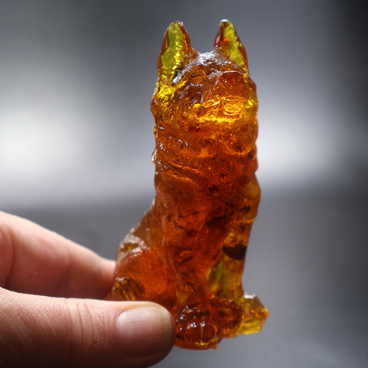 Baltic amber German Shepherd figurine held in hand showing size, KIZIMA amber manufactory
