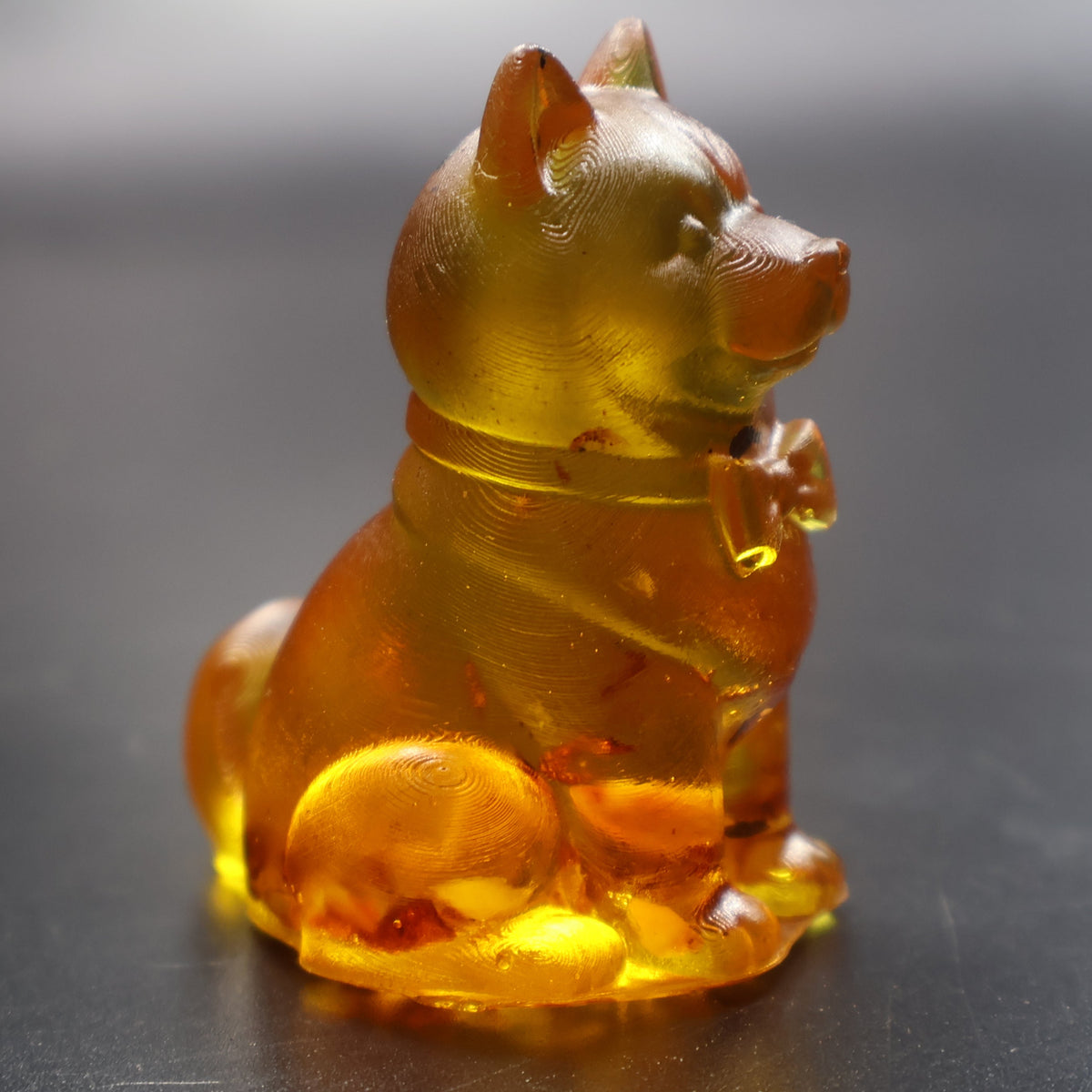 Golden Baltic amber playful puppy figurine with ball at paw, handmade in Brooklyn New York