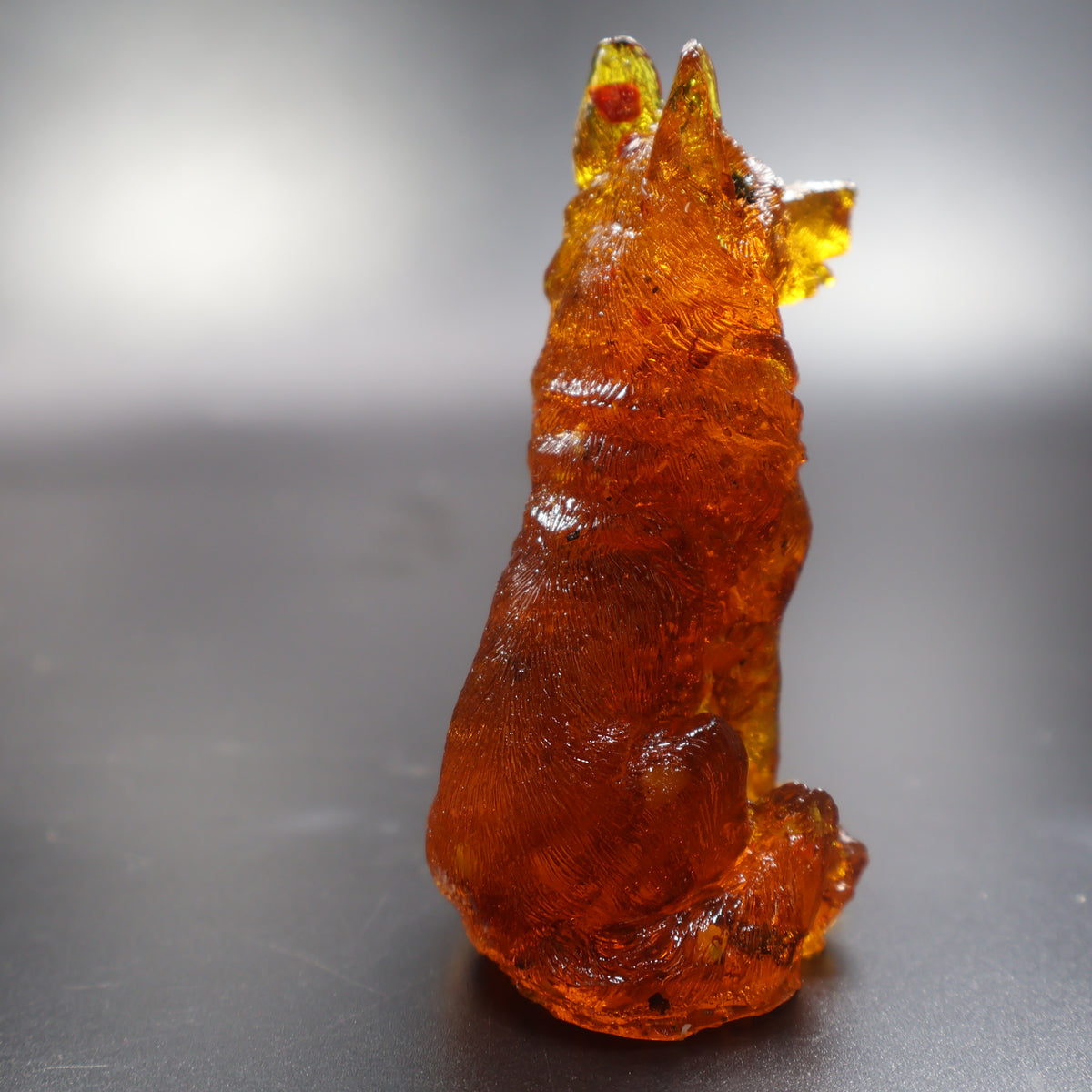 Natural Baltic amber shepherd dog figurine glowing in light, collectible Made in USA