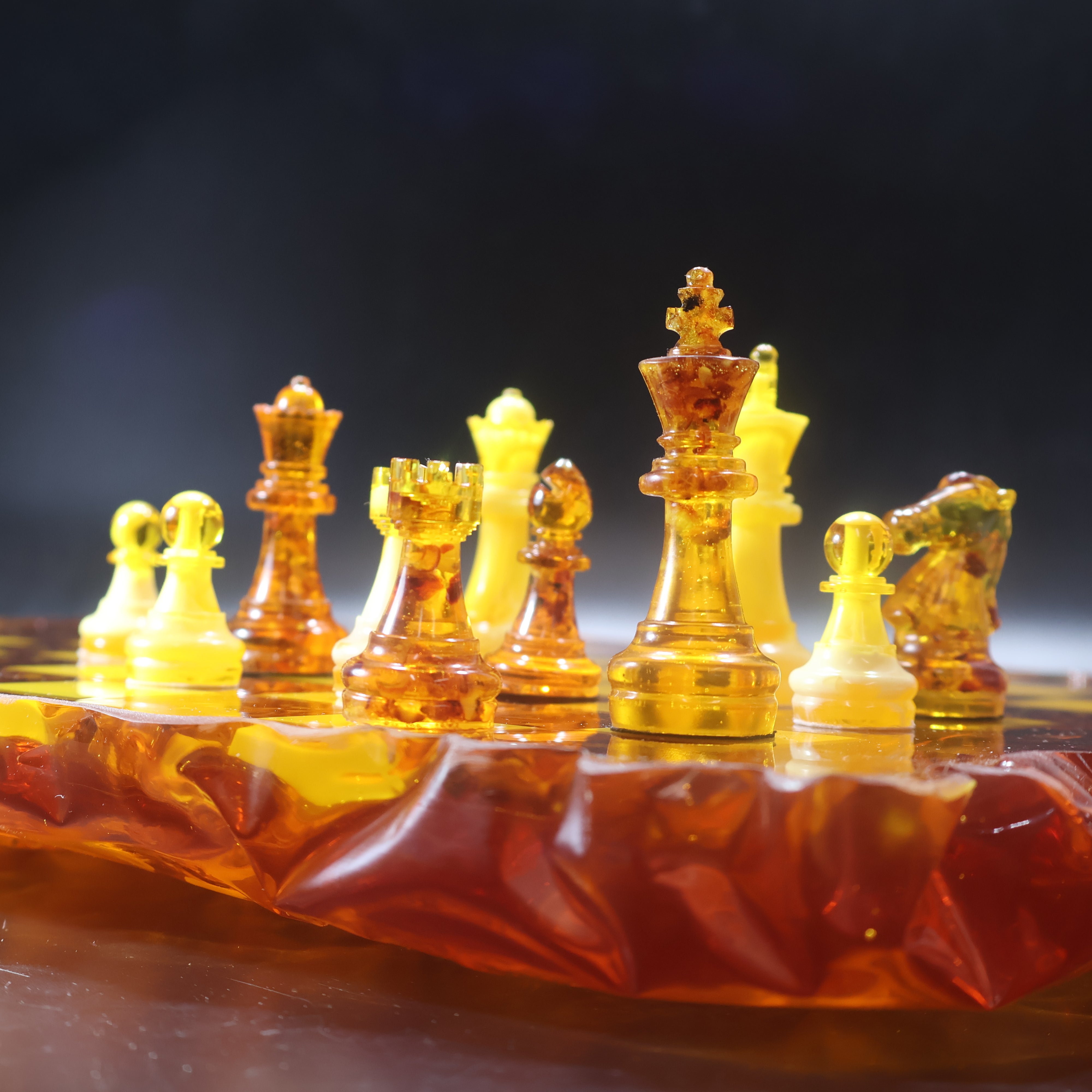 Luxury amber chess board with glowing yellow squares and natural Baltic amber inclusions, KIZIMA USA