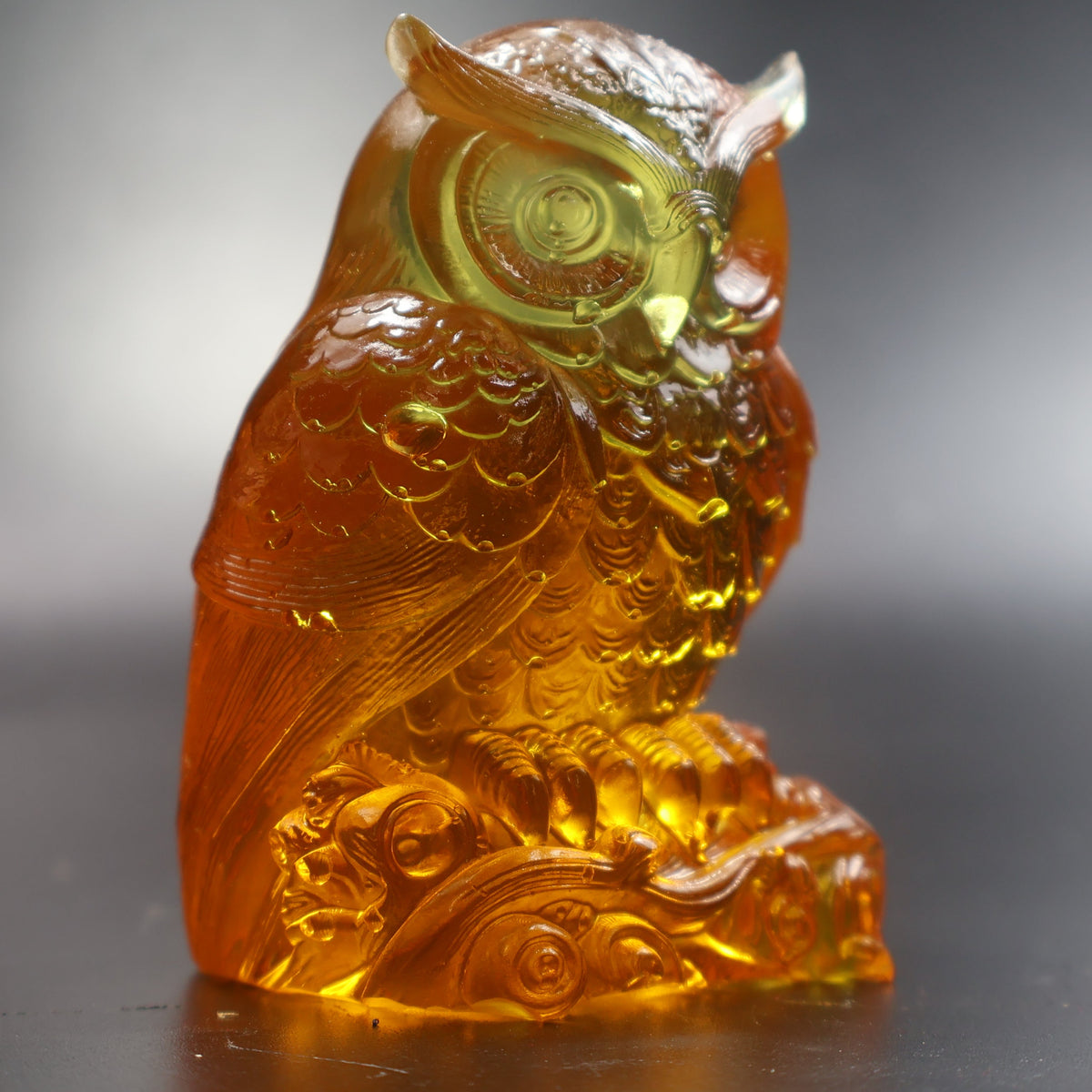 Natural Baltic amber owl sculpture back view showing feather carving, KIZIMA Brooklyn