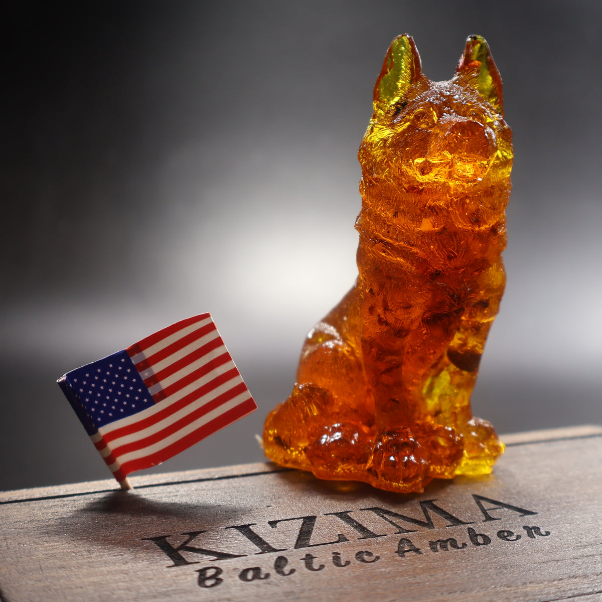 Cognac Baltic amber German Shepherd figurine on KIZIMA branded display, handmade in Brooklyn