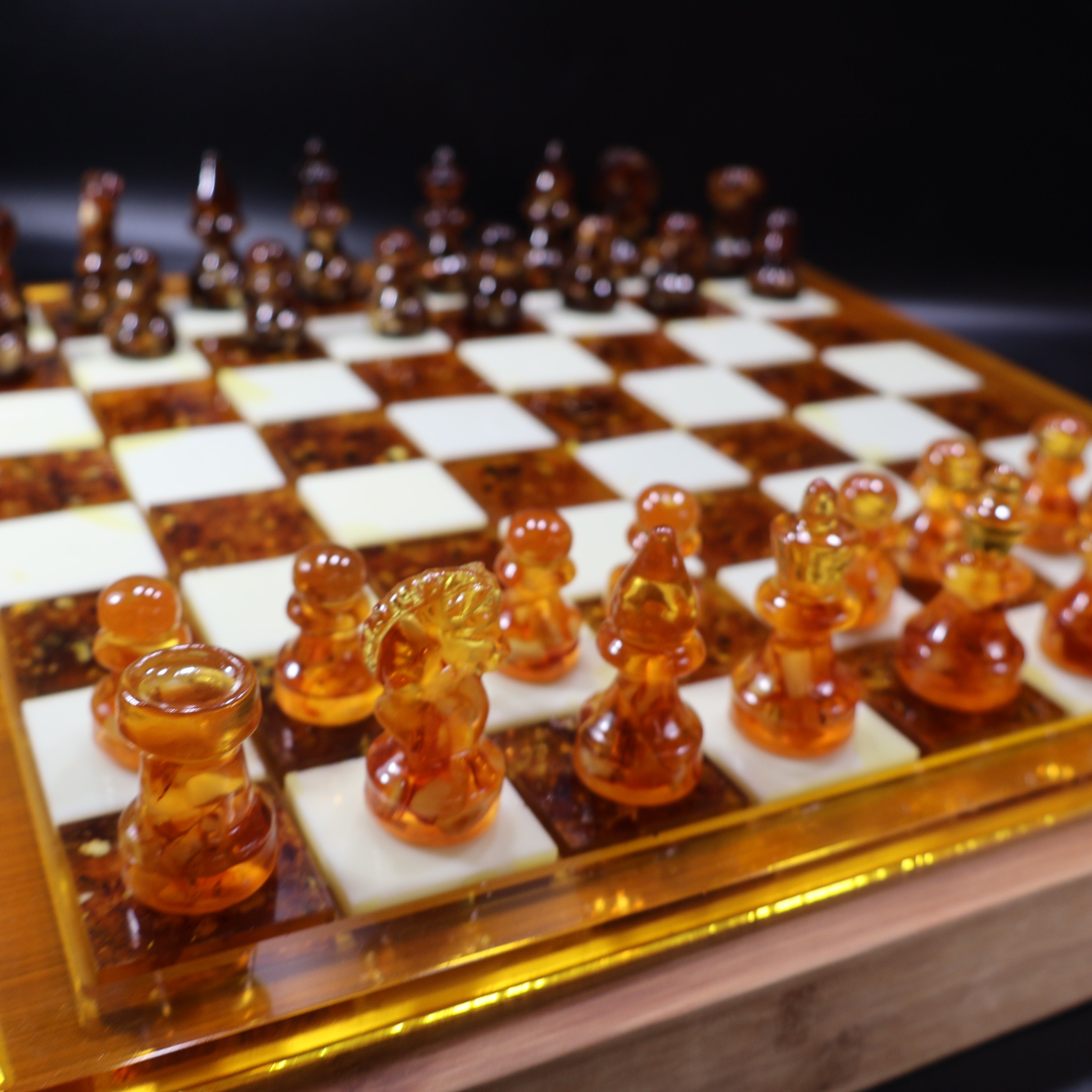 Honey and cognac amber chessmen on natural wood chess board, KIZIMA USA