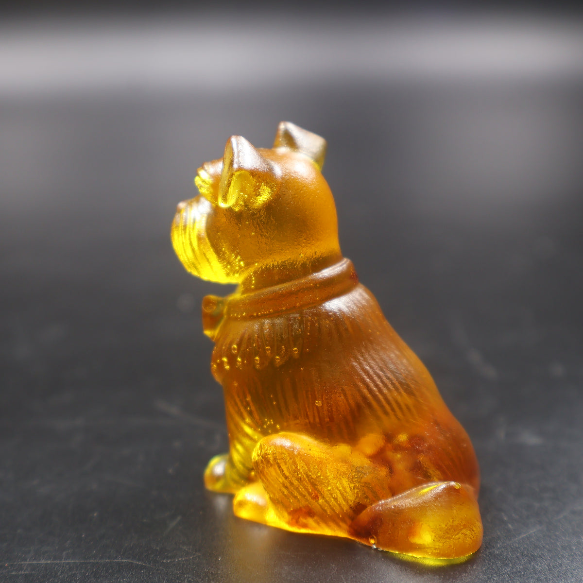 Baltic amber sitting Schnauzer dog miniature sculpture, honey gold color