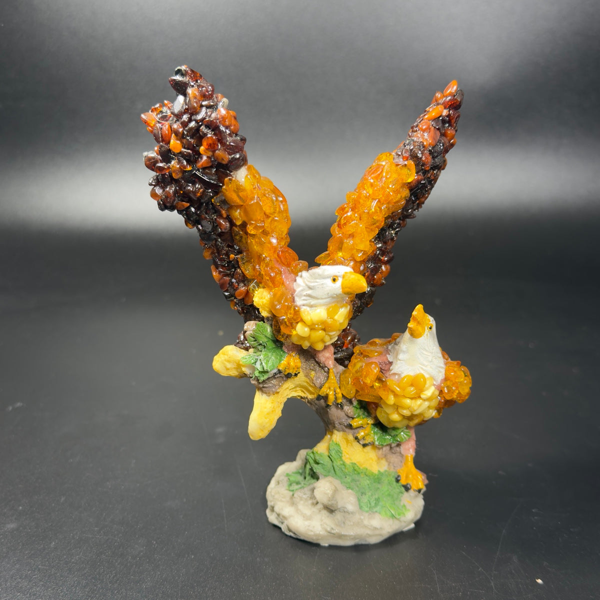 Original front photograph of KIZIMA Baltic amber two-eagle sculpture on a leafy branch, SKU 18-02Q200-3-5-6.
