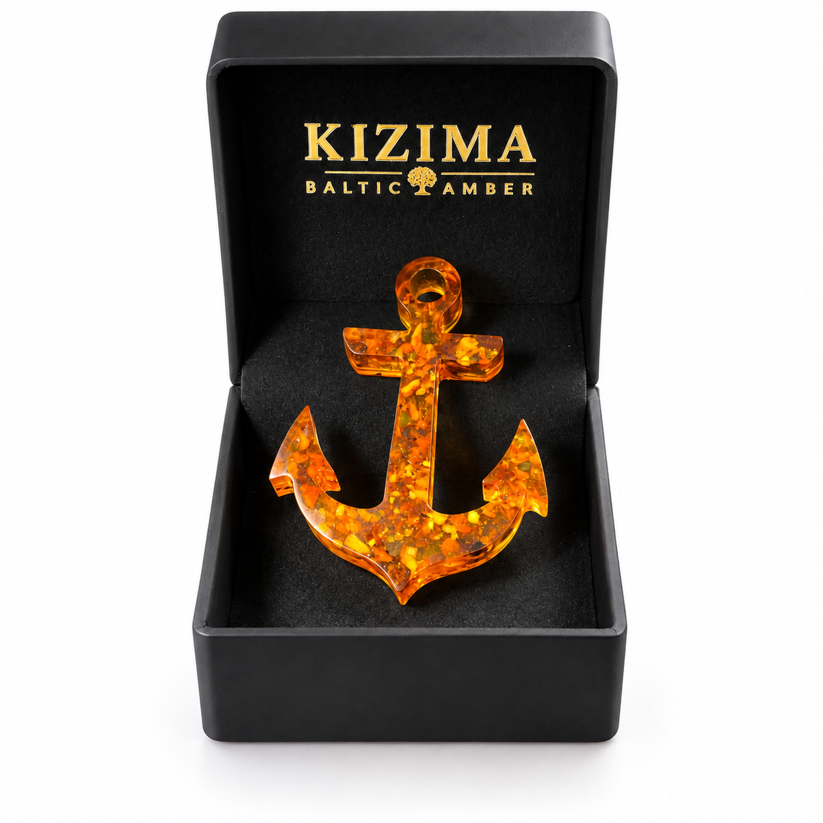 Baltic amber anchor presented inside an open black KIZIMA gift box with gold lettering on white.