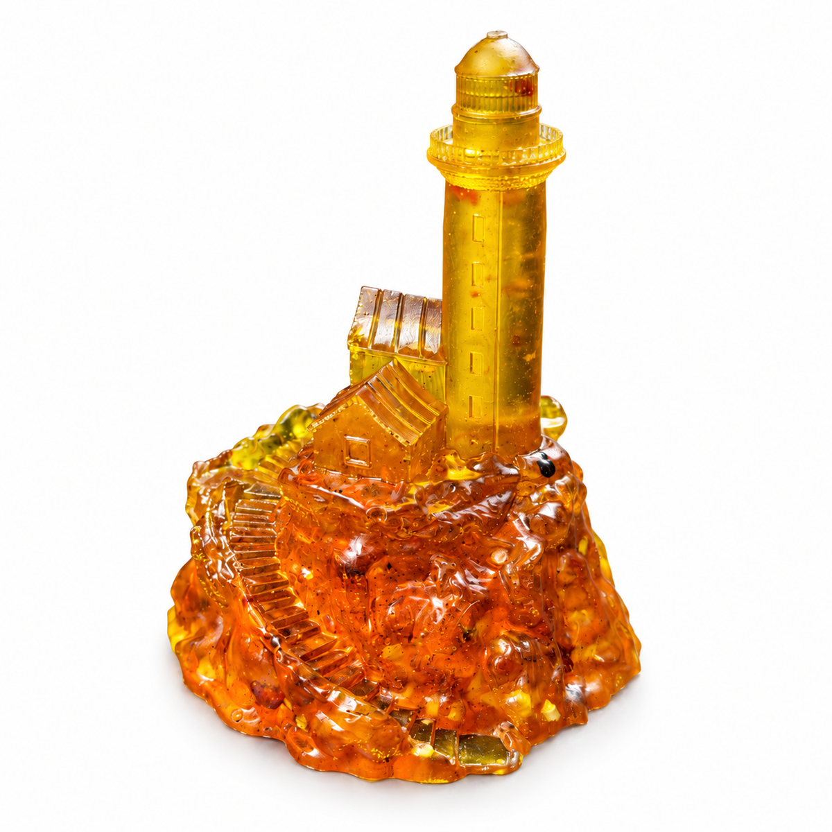 Front three-quarter view of the golden amber lighthouse figurine, showing its keeper houses, stone steps and amber-filled base on pure white.