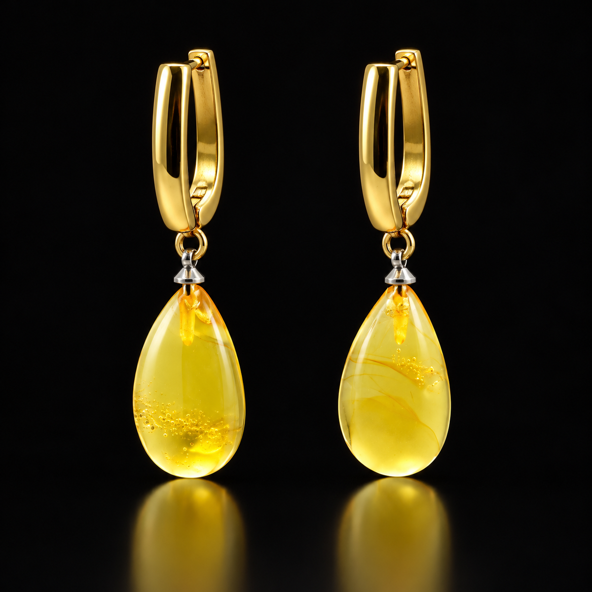 KIZIMA lemon-yellow amber teardrop earrings with gold-plated hoops and silver-tone cone connectors on black.