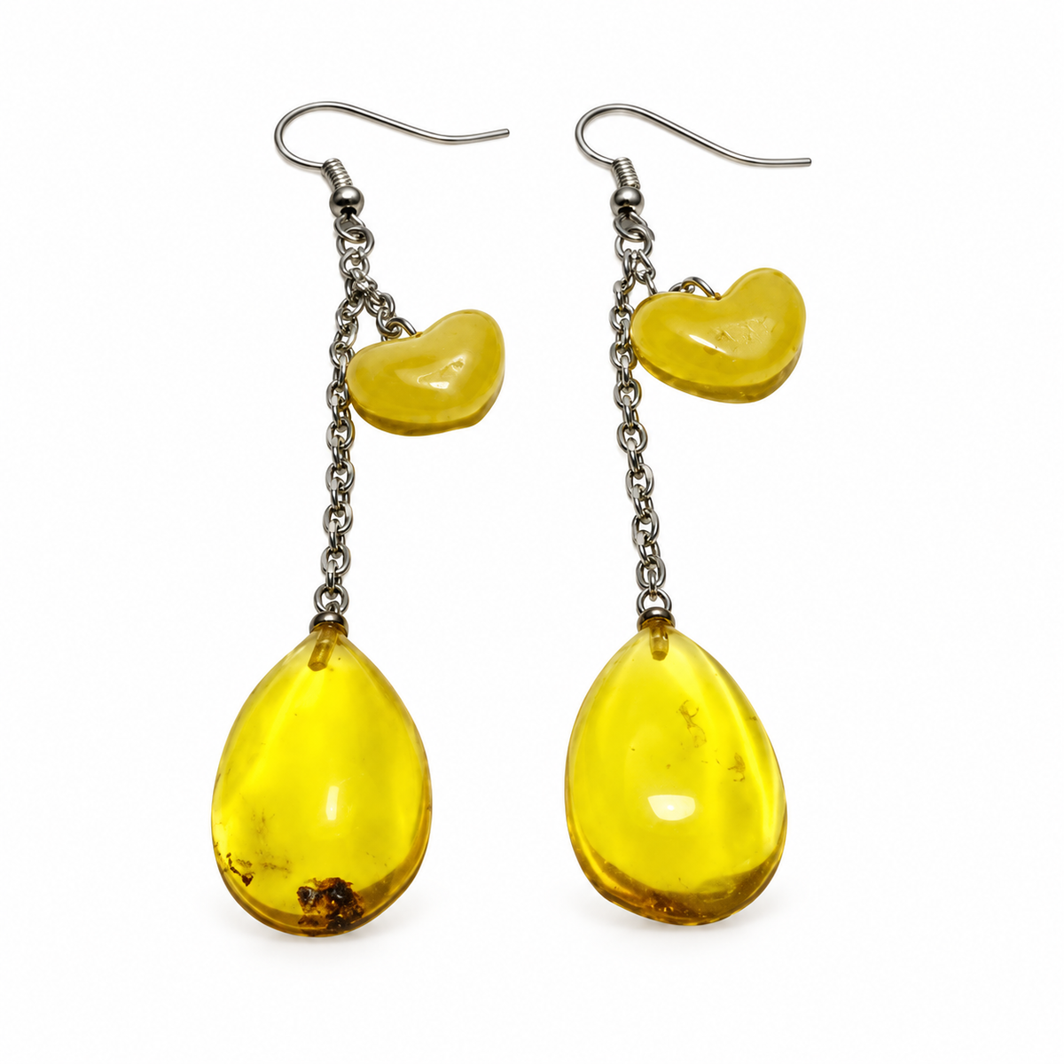 KIZIMA yellow amber teardrop and curved-charm earrings with silver-tone fishhooks isolated on white.