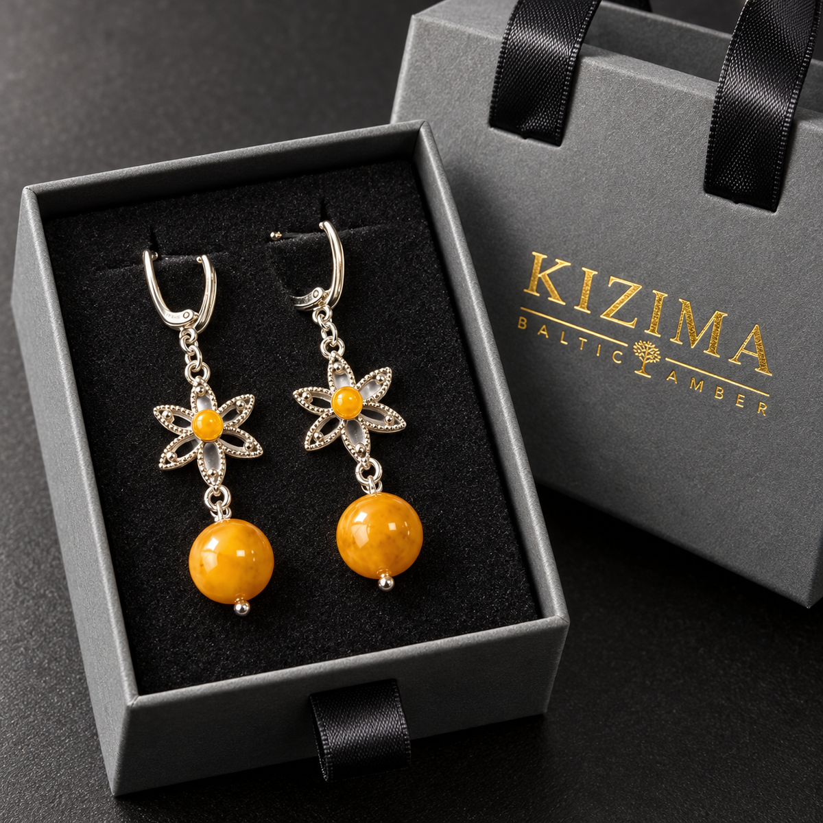 KIZIMA yellow amber flower and bead dangle earrings in the gray KIZIMA Baltic Amber gift box with black velvet insert.