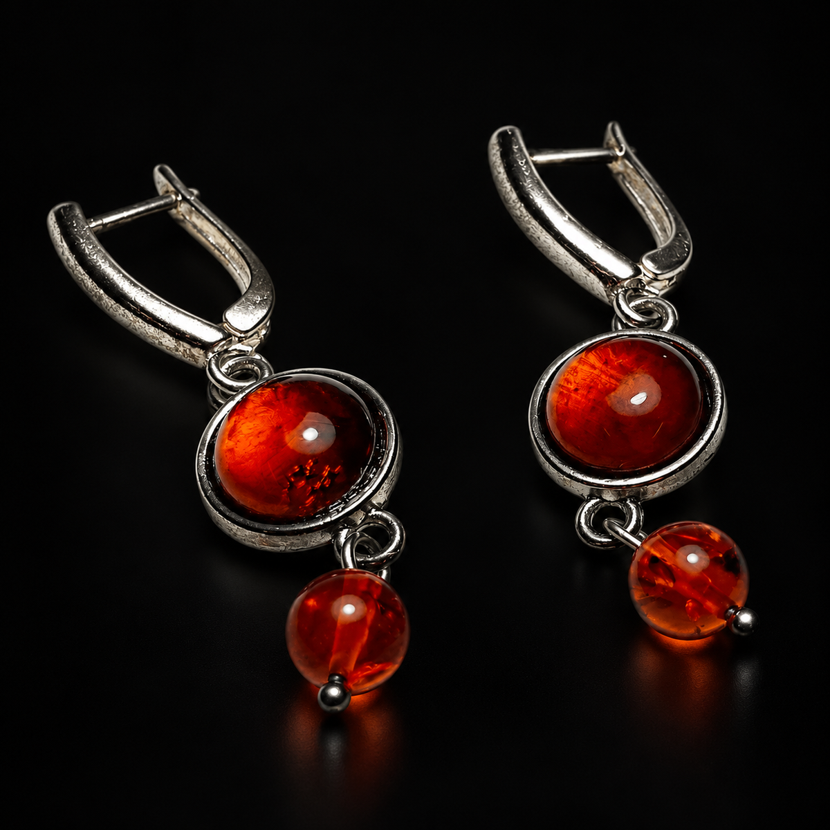 KIZIMA cognac amber earrings with round rimmed cabochons and smaller ball drops, black studio view, SKU 5N0400q4-23.