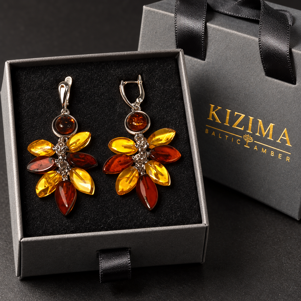Multicolor amber bouquet earrings in a charcoal gray KIZIMA ribbon-handle gift box with black insert.