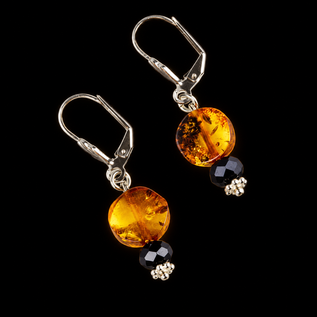 KIZIMA honey amber disc drop earrings with black faceted beads and silver-tone leverbacks on a black studio background