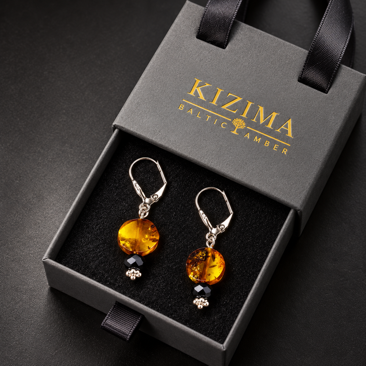 KIZIMA amber disc drop earrings pair in the signature charcoal gray drawer gift box with black ribbons and gold logo, SKU 5G0250q2.29