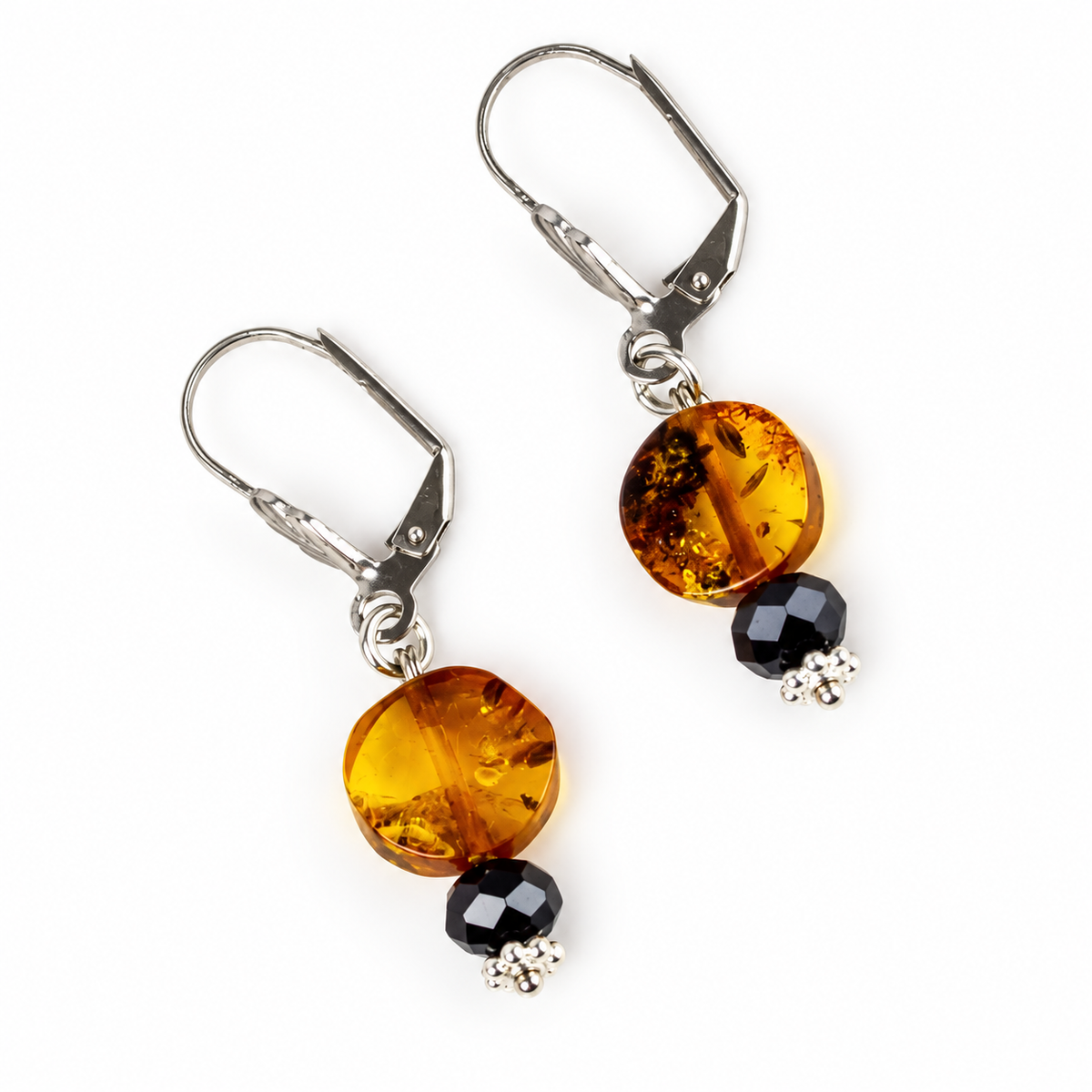 KIZIMA honey amber disc drop earrings with black faceted beads and silver-tone leverbacks on a white background