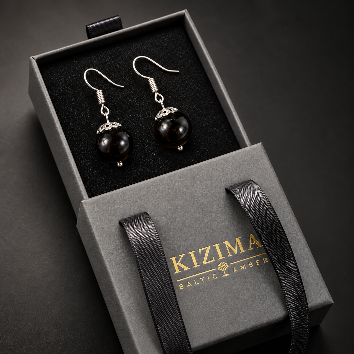 KIZIMA black amber fishhook earrings pair in the signature charcoal gray drawer gift box with black ribbons and gold logo, SKU 662987478915