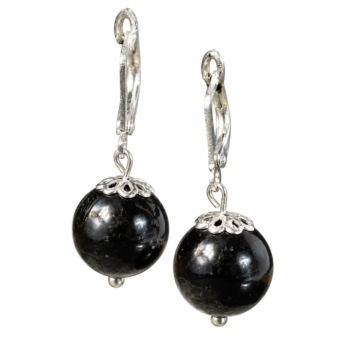 Pair of KIZIMA black Baltic amber sphere earrings with silver-tone leverbacks isolated on a white background