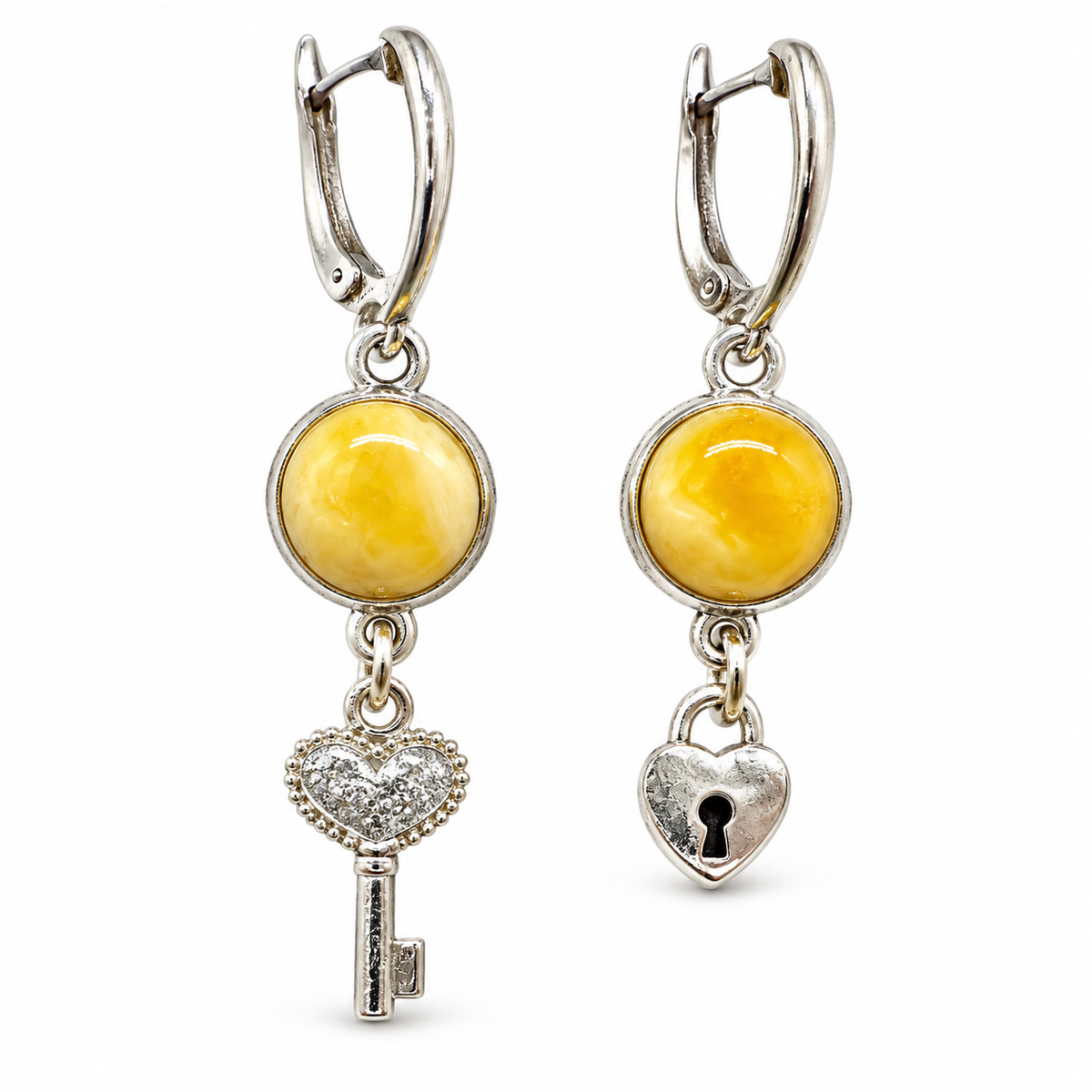KIZIMA yellow amber oval earrings with a heart-bow key and heart padlock charms, isolated as a pair on white.