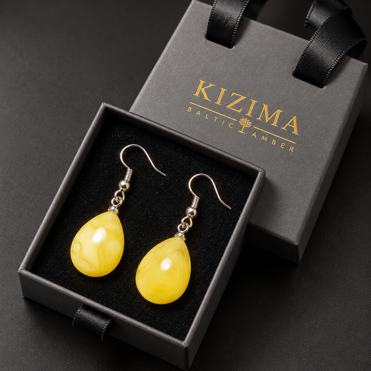 KIZIMA yellow amber teardrop earrings pair in the signature charcoal gray drawer gift box with black ribbons and gold logo, SKU 662987478946