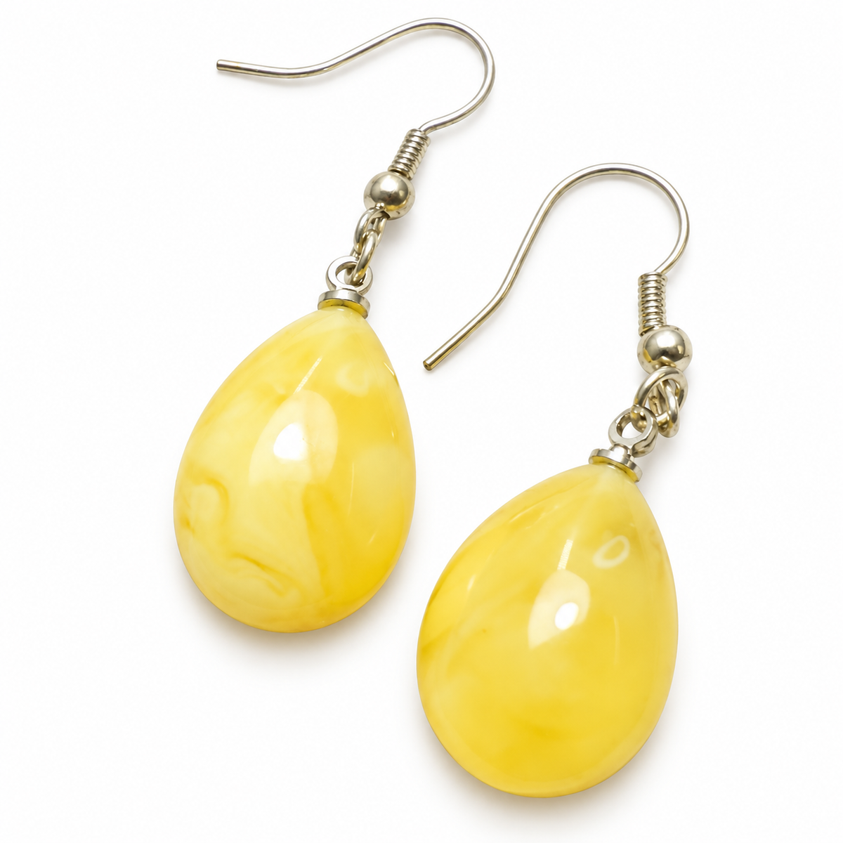 KIZIMA butter-yellow Baltic amber teardrop earrings with silver-tone fishhooks on a white background