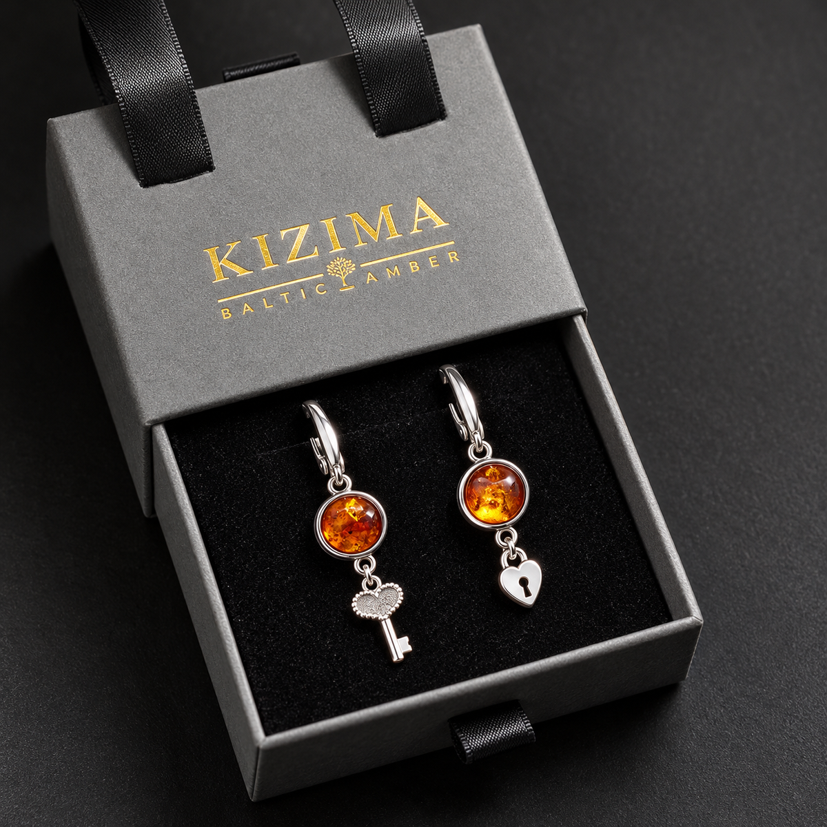 KIZIMA cognac amber key lock earrings pair in the signature charcoal gray drawer gift box with black ribbons and gold logo, SKU 662987479028
