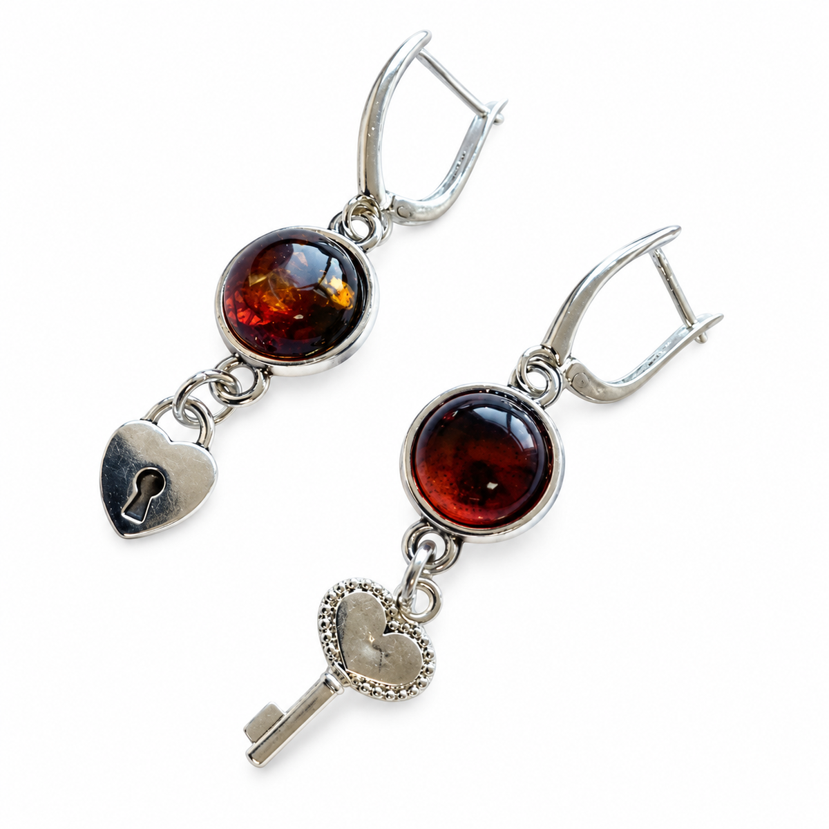 KIZIMA cognac amber asymmetric key and heart-lock earrings with silver-tone leverbacks on a white background
