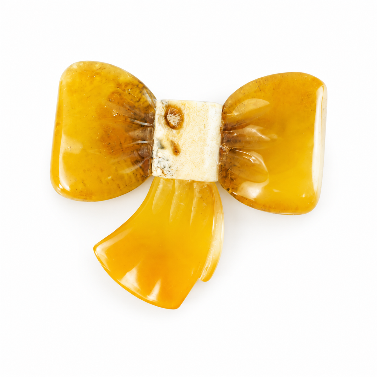 KIZIMA amber bow brooch on white studio background.