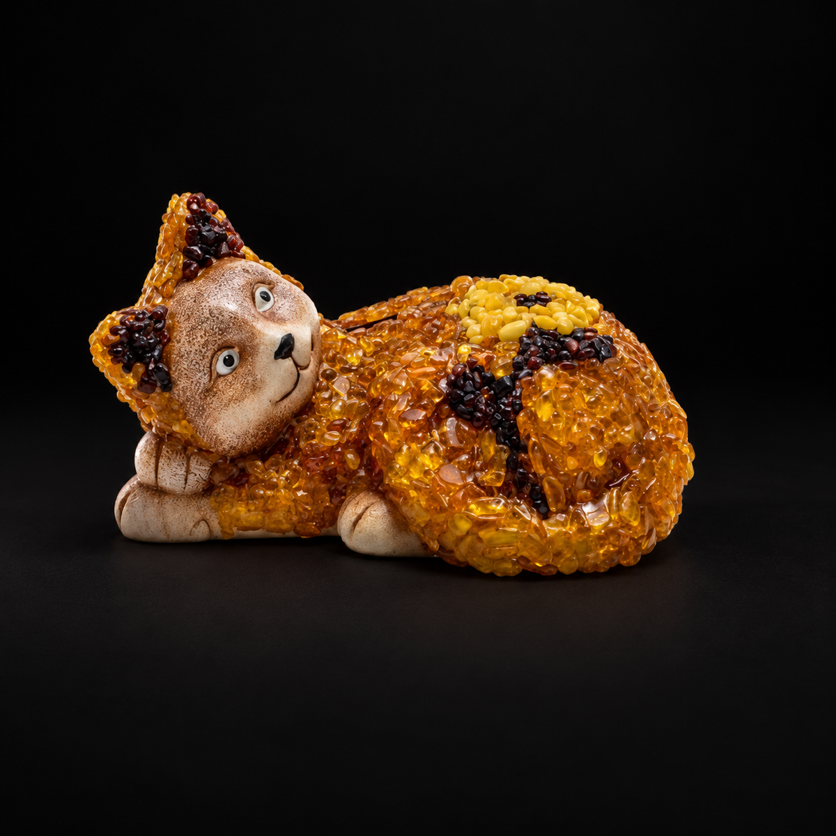 KIZIMA amber reclining cat money box with a floral motif on a matte black background