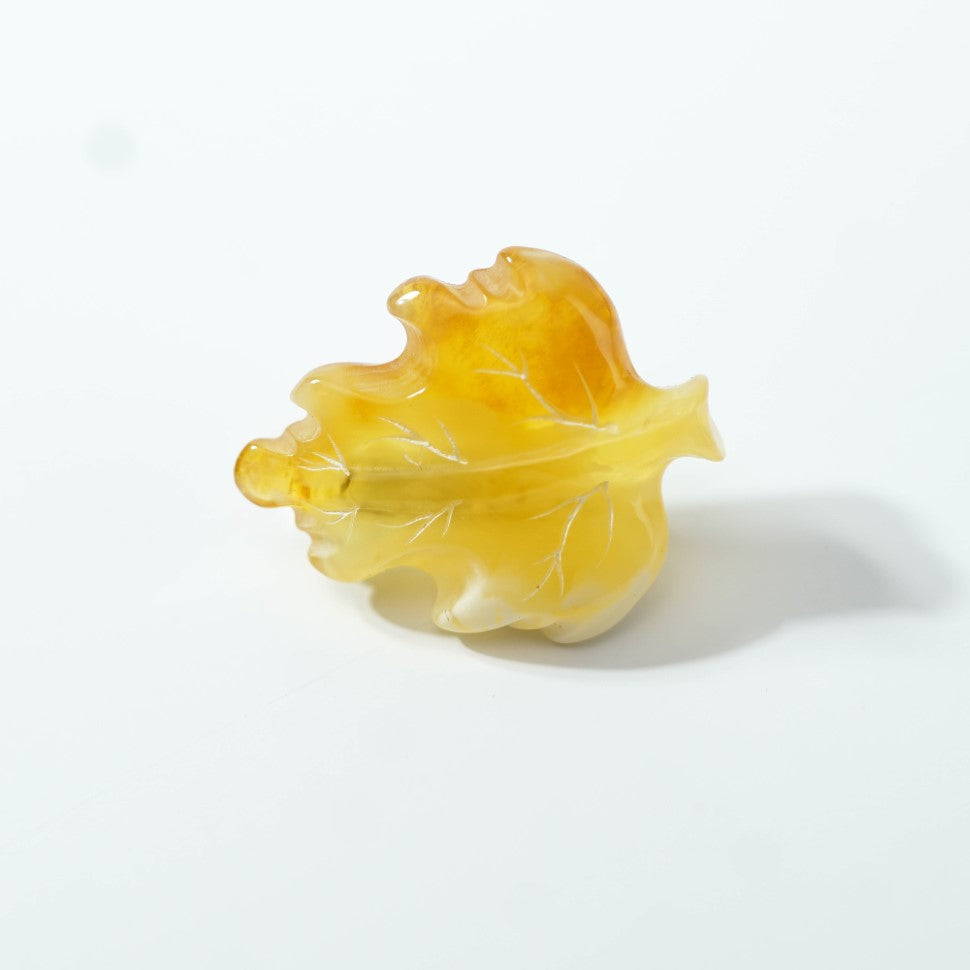 Yellow amber leaf brooch with carved veins on a light surface; an autumn birthday gift for a nature lover.