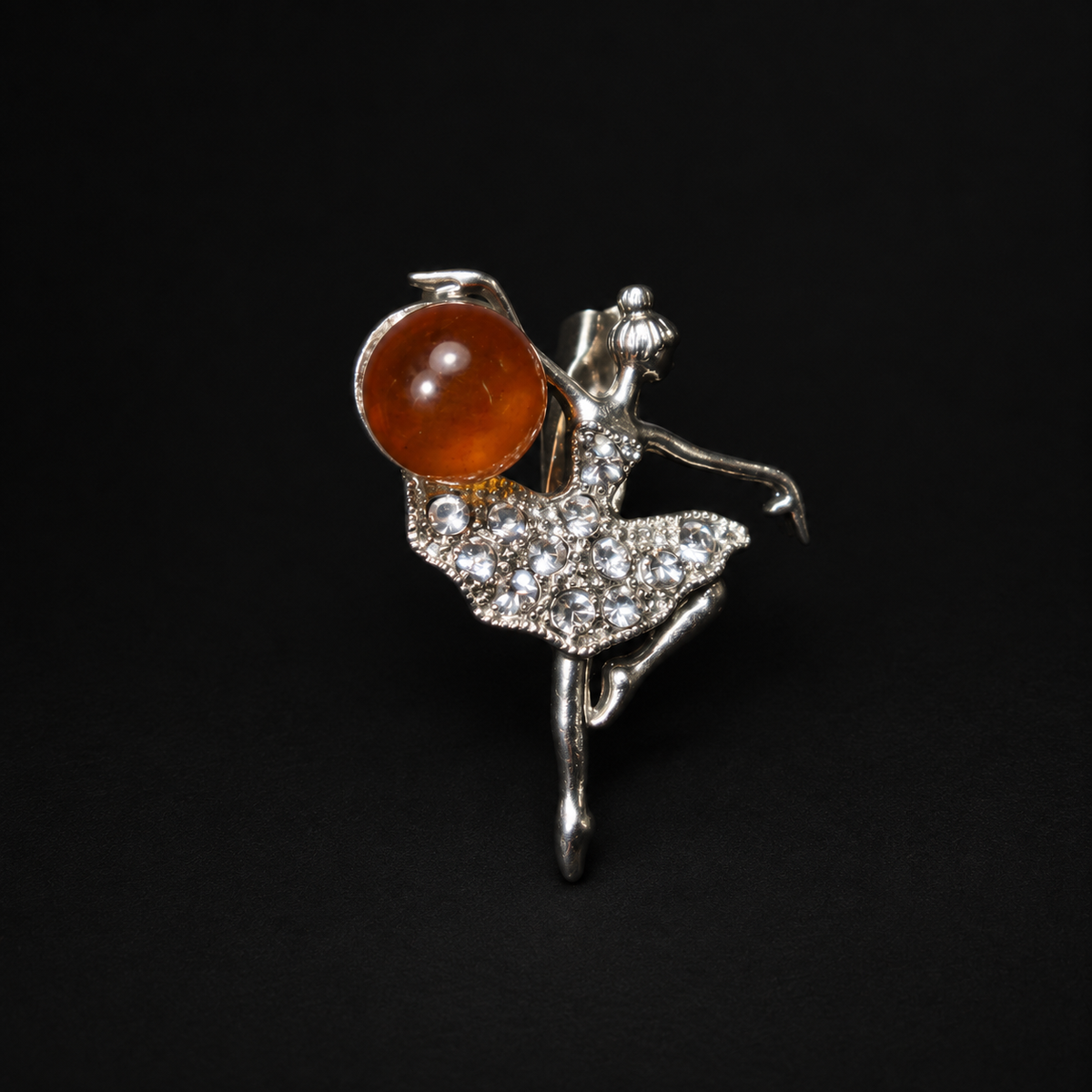 KIZIMA silver-tone Baltic amber ballerina brooch 20N0120-Group4 on a deep black studio background, with round cognac amber and clear rhinestone tutu