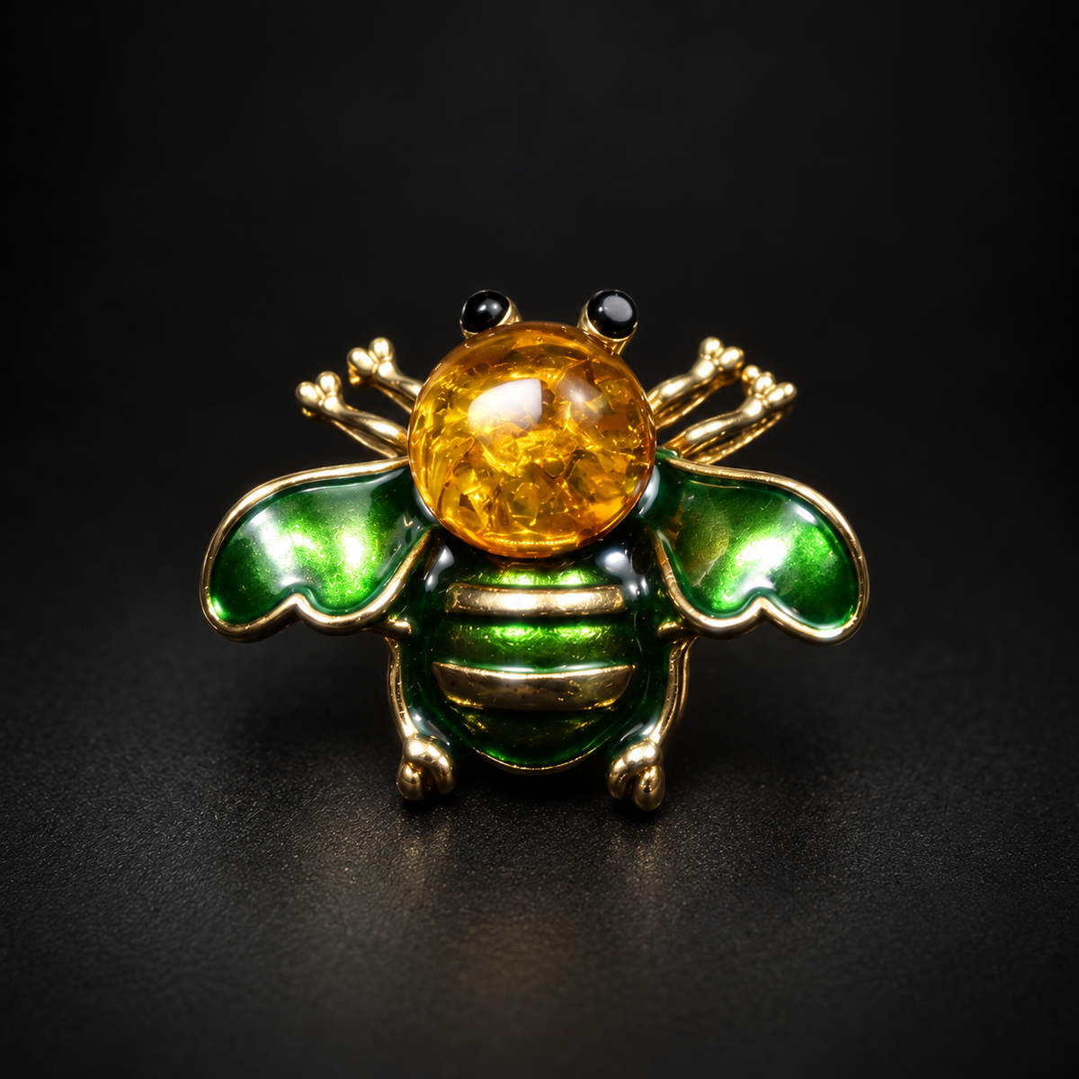 KIZIMA green enamel and golden Baltic amber bee brooch 20-310Q5-3-3-2 on a black studio background.