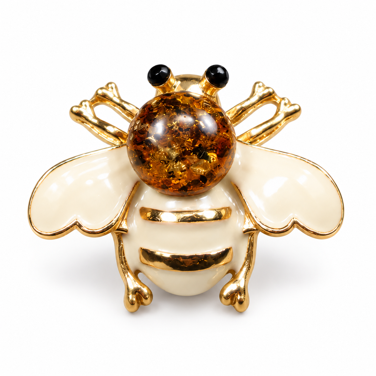 KIZIMA cream-white enamel bee brooch 20N0120-39 with round Baltic amber on a white studio background.