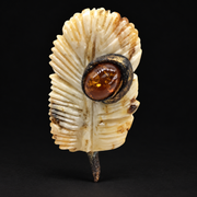 KIZIMA amber brooch 20E2500q5.61, on a black background.